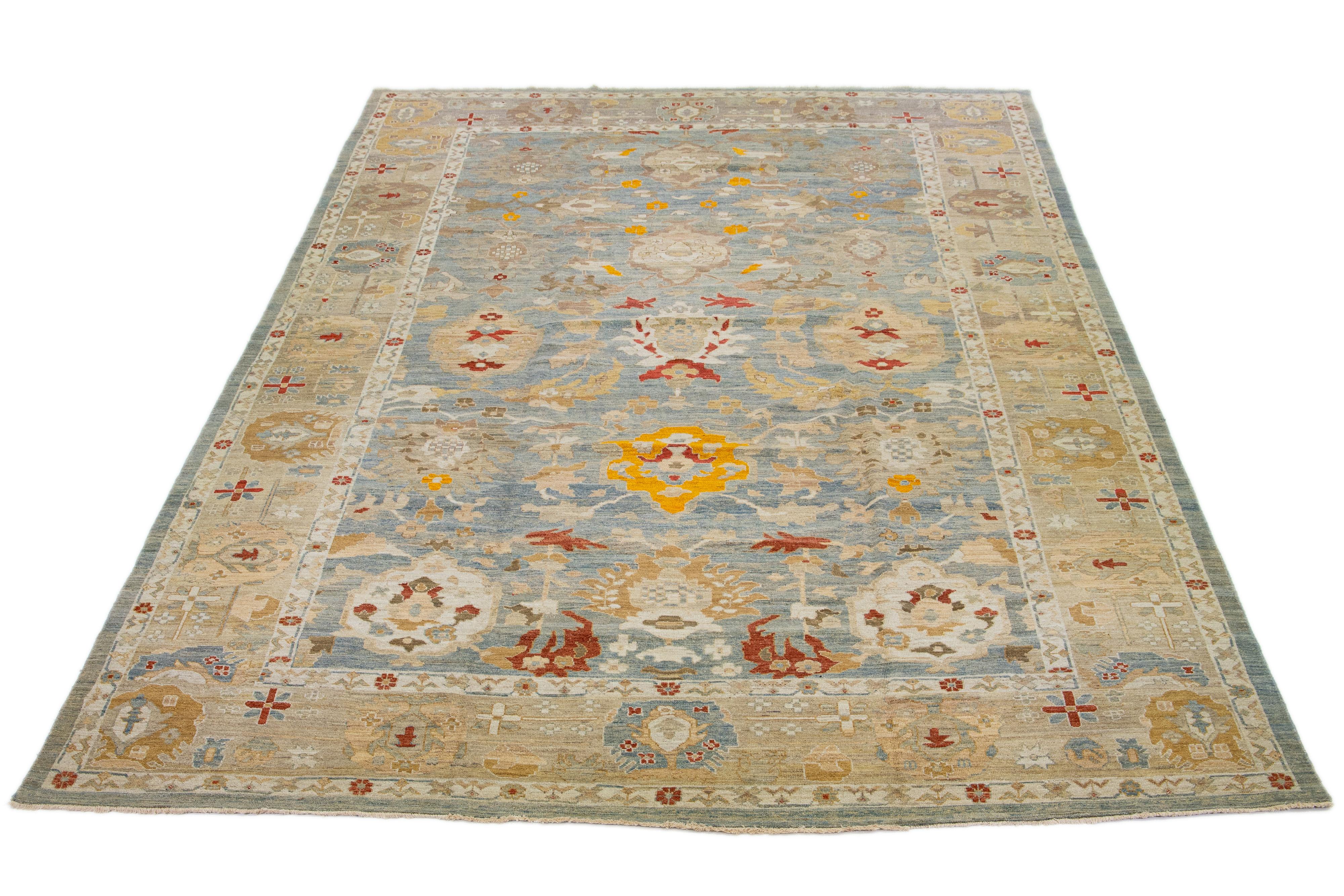 A stunning, contemporary Sultanabad rug made of oversized wool. It features a blue field adorned with multicolored accents and an all-over floral design.

This rug measures 11'10