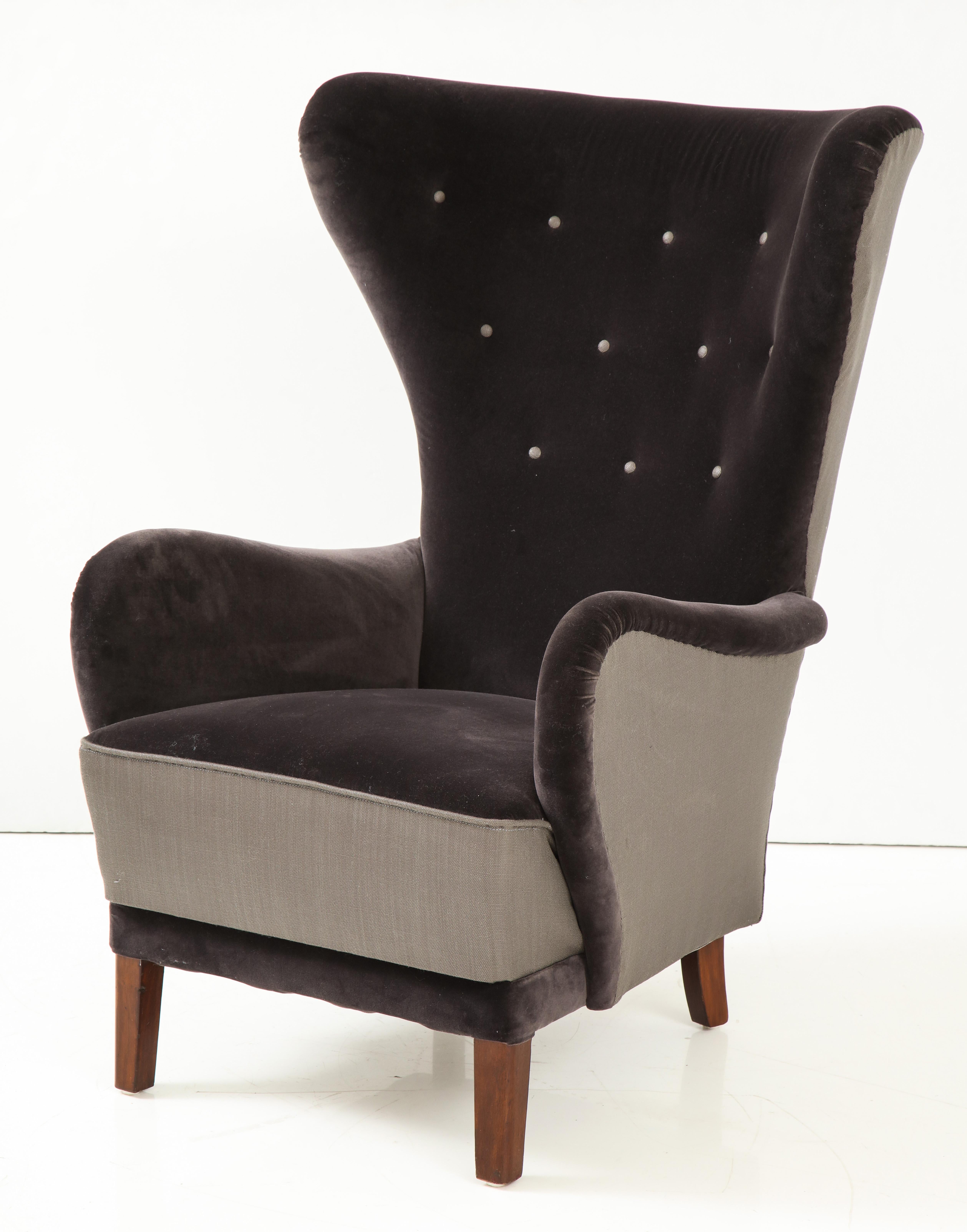 A Danish modern oversize upholstered armchair, circa 1950s, with new two-tone velvet and linen tufted upholstery. Great scale and comfort.