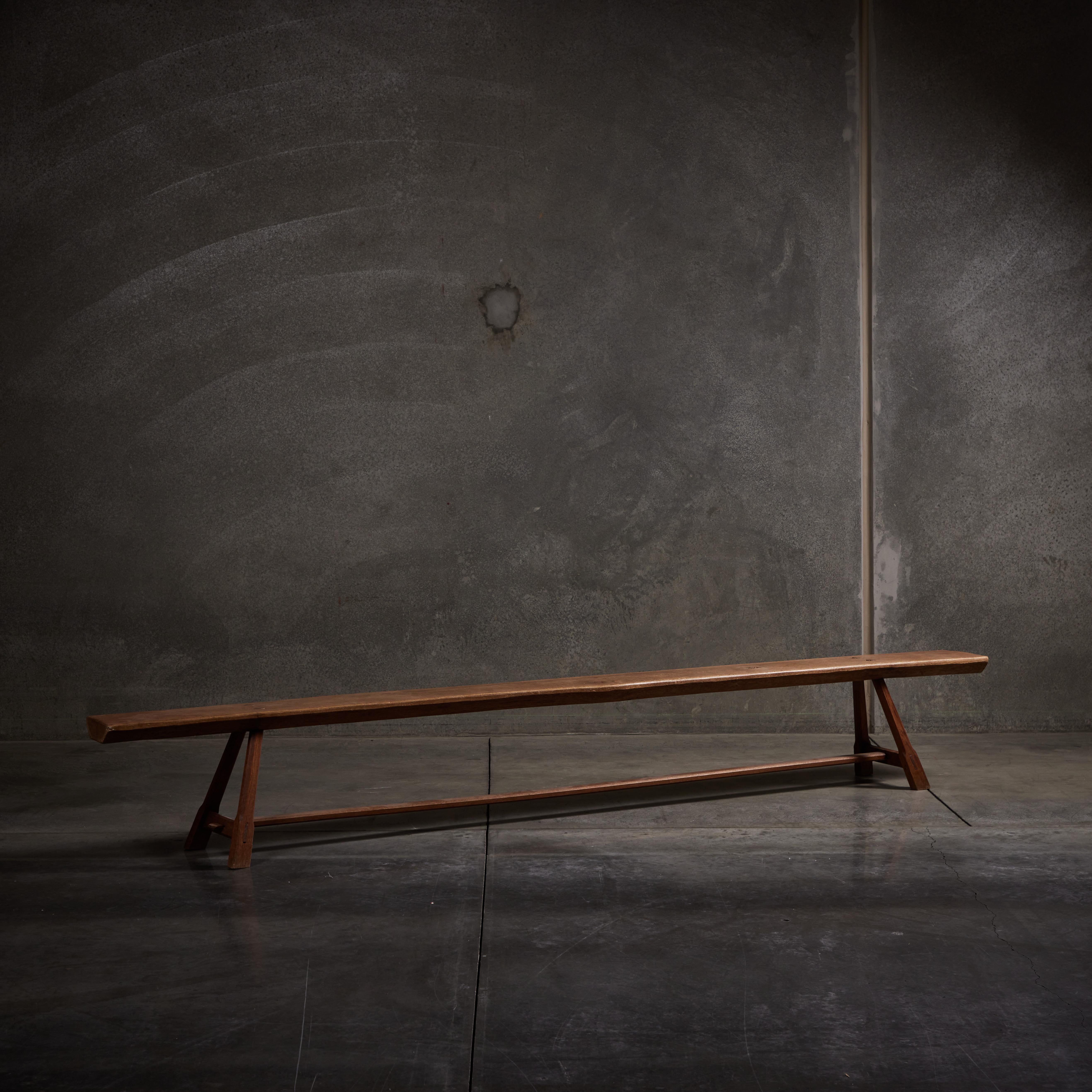 Extra long handmade oak trestle bench. Made in France circa early 20th century.