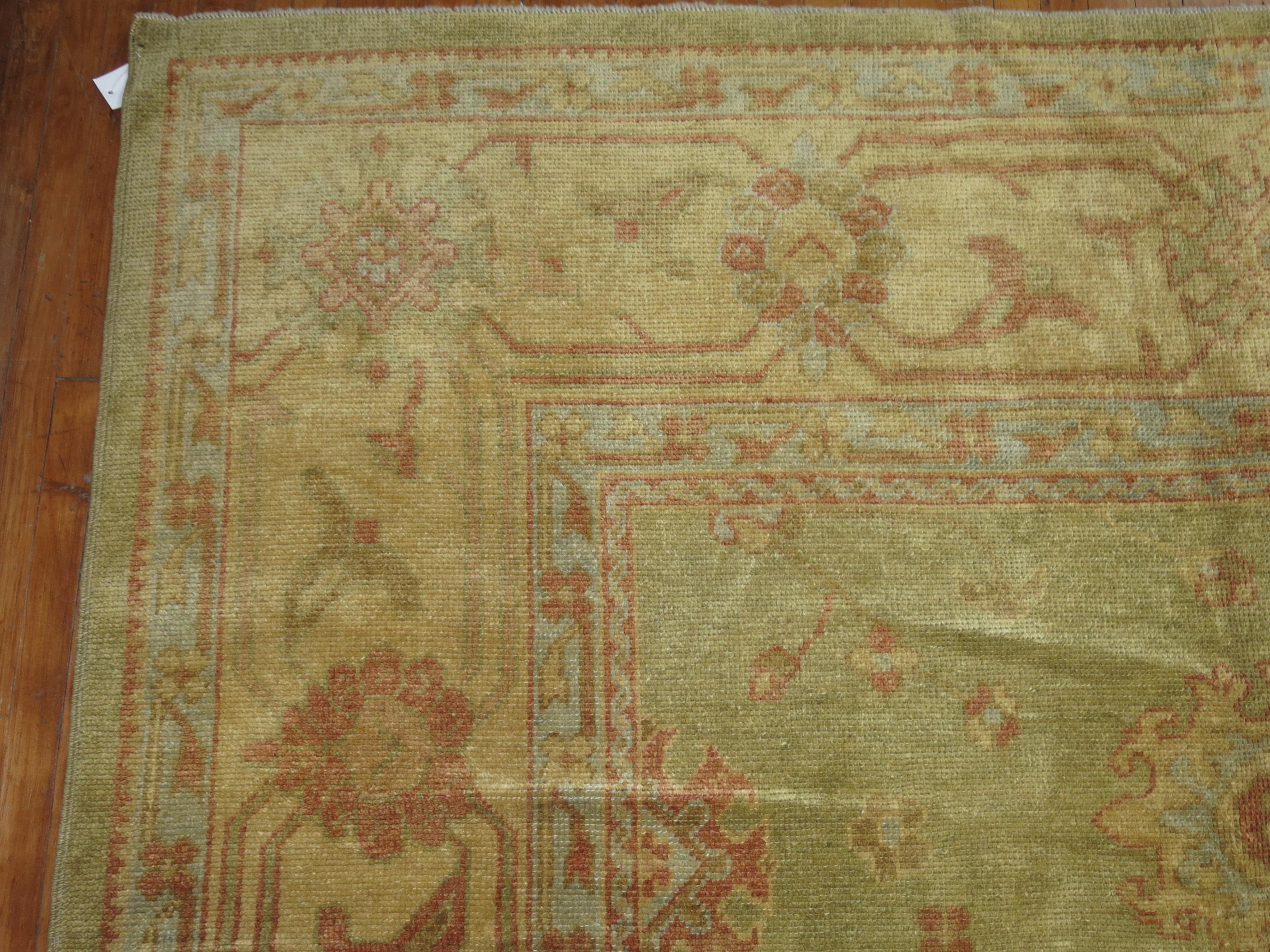 One of a kind traditional wool 21st century Turkish Oushak in muted green and gold tones, accents in brick red

Measures: 12'5