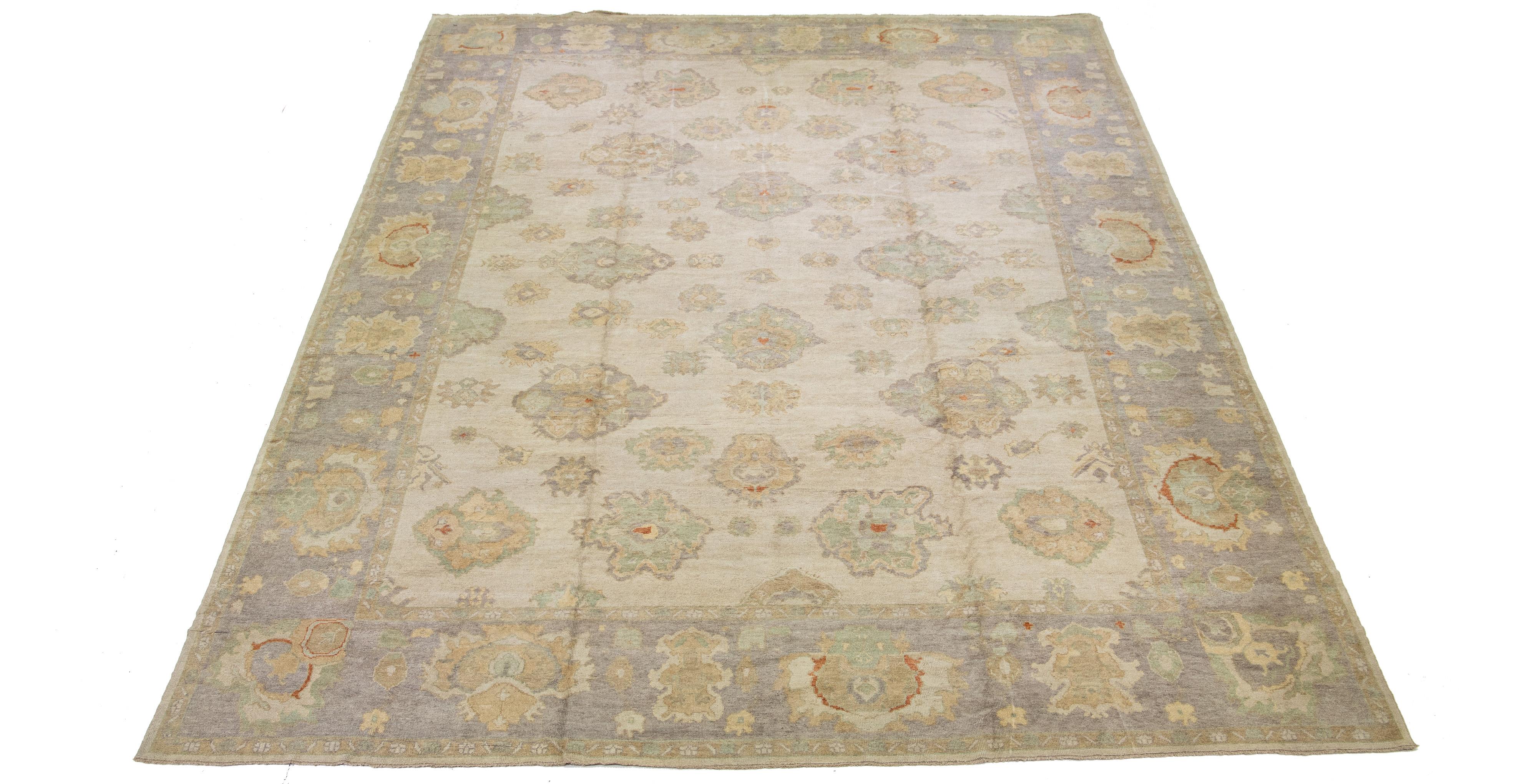 This Turkish wool rug, styled in antique fashion, showcases a delightful beige foundation. It's carefully hand-knotted focusing on every detail. The rug is enhanced by beautiful green, gray, and brown accents and presents an enticing floral design