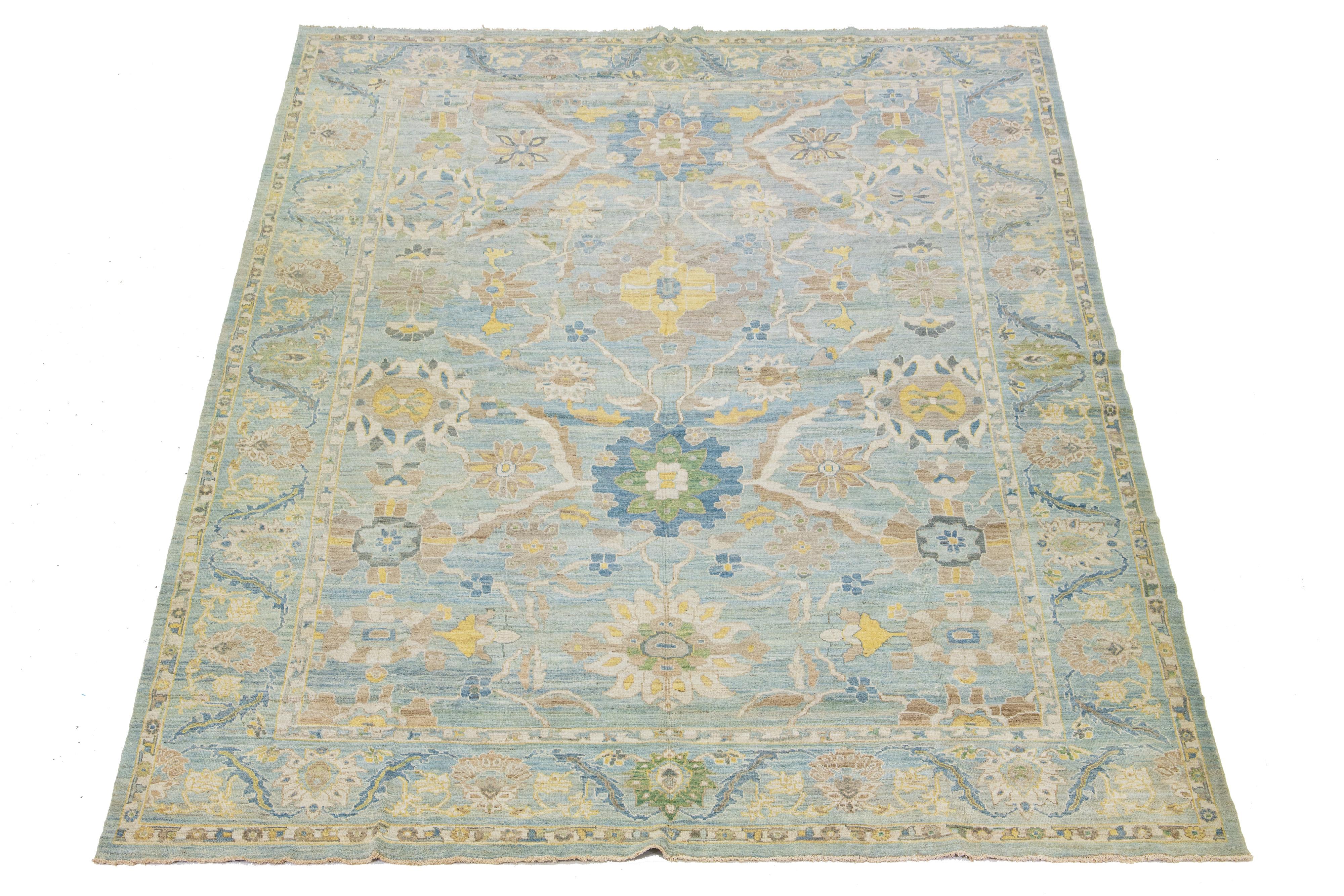 This Sultanabad classic style has been meticulously transformed into a contemporary masterpiece. This wool rug is a blue field. Its frame has a floral motif. It incorporates a design of brown, yellow, and green accents to enhance its elegance.

This