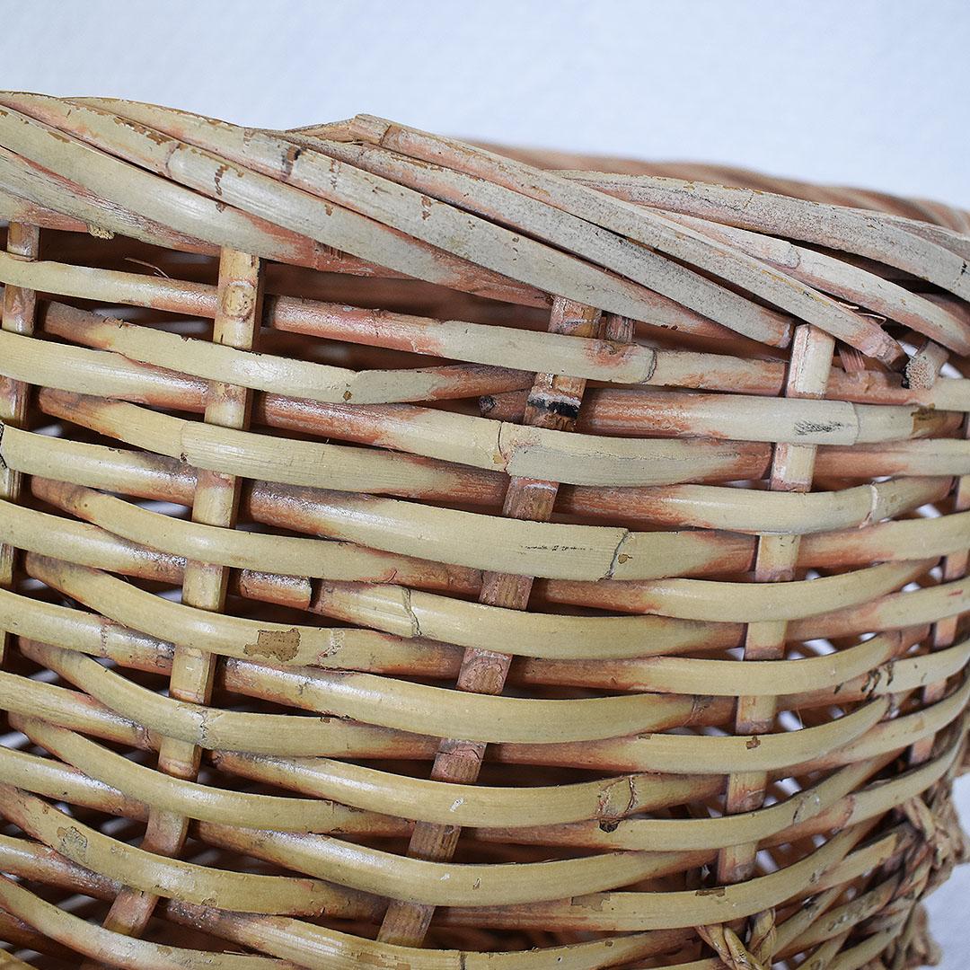 Large oversize brown wicker basket in the shape of a shoe. Created from handwoven wicker, bamboo, or rattan, this lovely piece is a great way to store items such as blankets, magazines, or any other items that may need to be hidden or tucked away.
