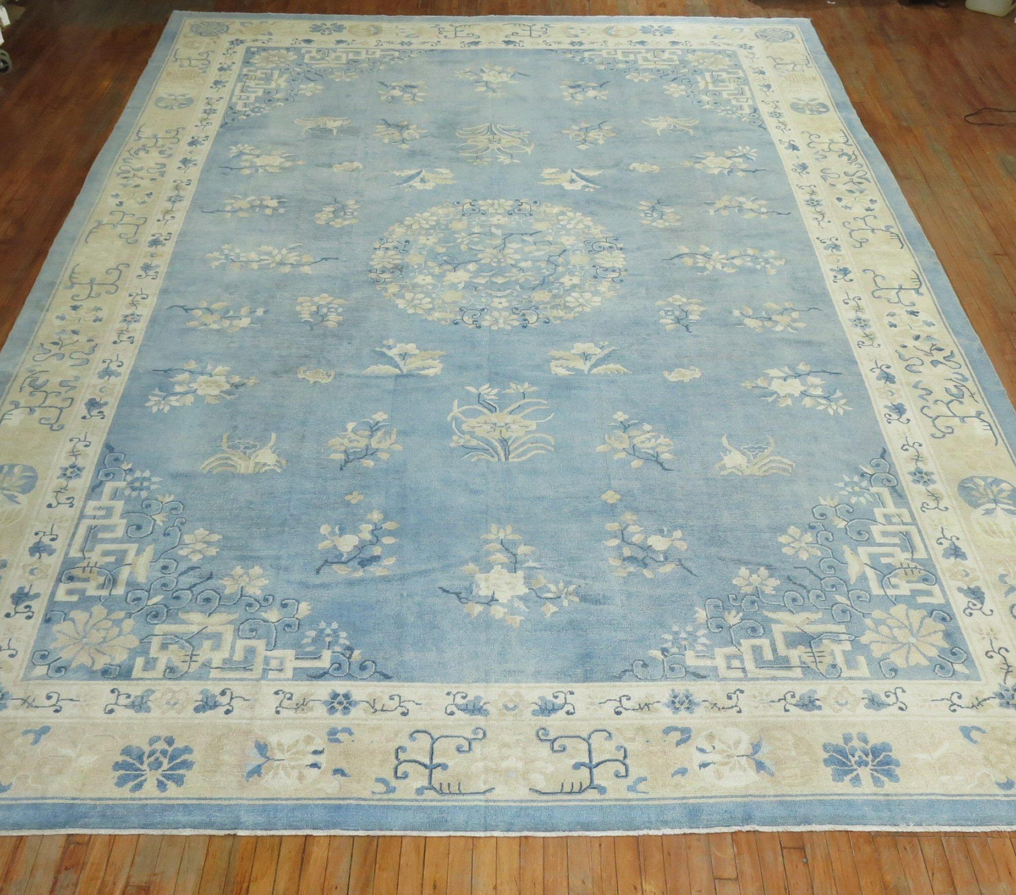 An early 20th century oversize one of a kind Chinese rug in various predominant light blues and creams. The wool and feel of the rug is very soft on the feet. It has a silky sheen to it as well. Wool on cotton foundation.

Measures: 12' x 17'10''.