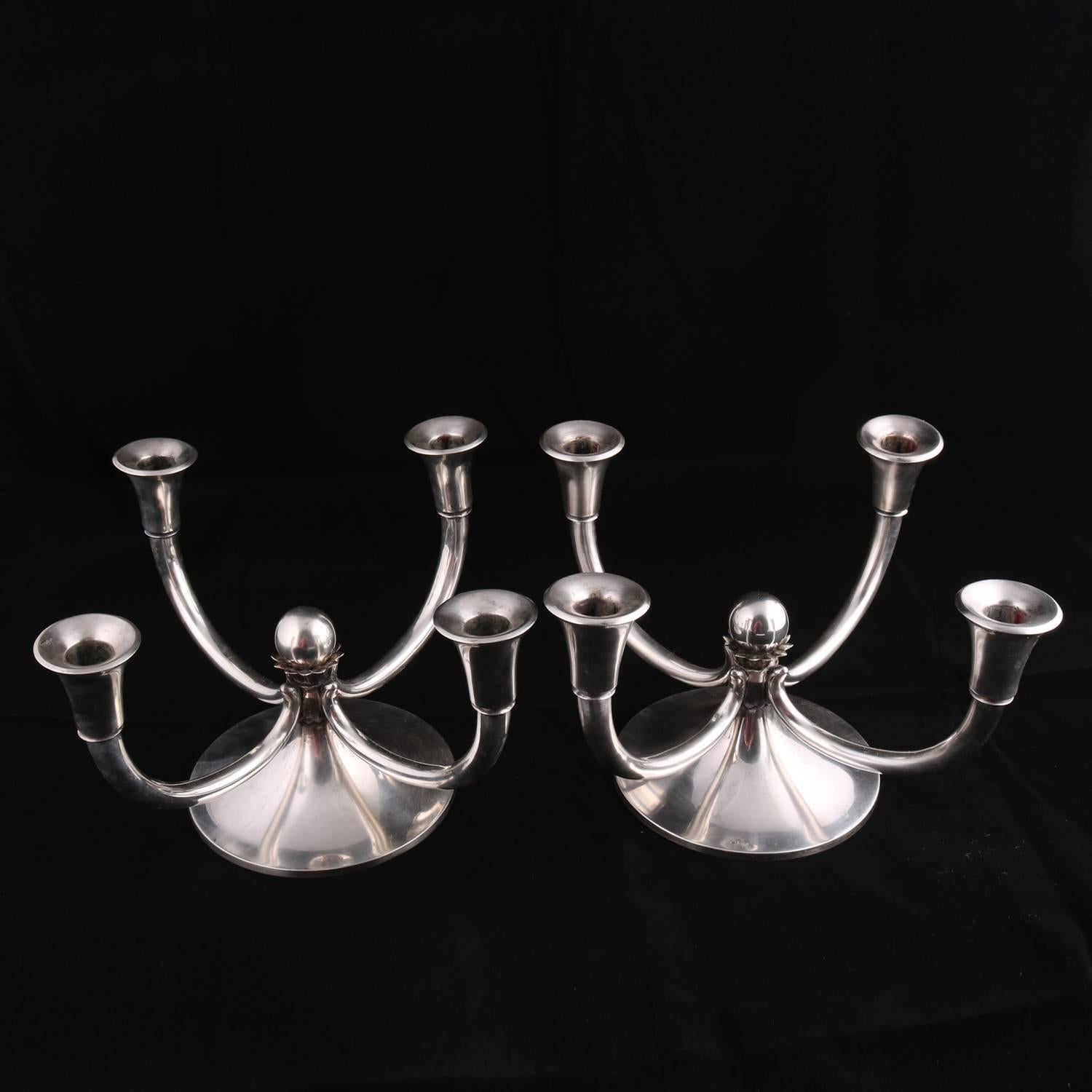 Pair of oversized Georg Jensen School .800 silver candelabra feature conical bases each with ball finial and four upswept arms terminating in flared candle sockets, 56.3 toz, circa 1970

Measures - 8.25