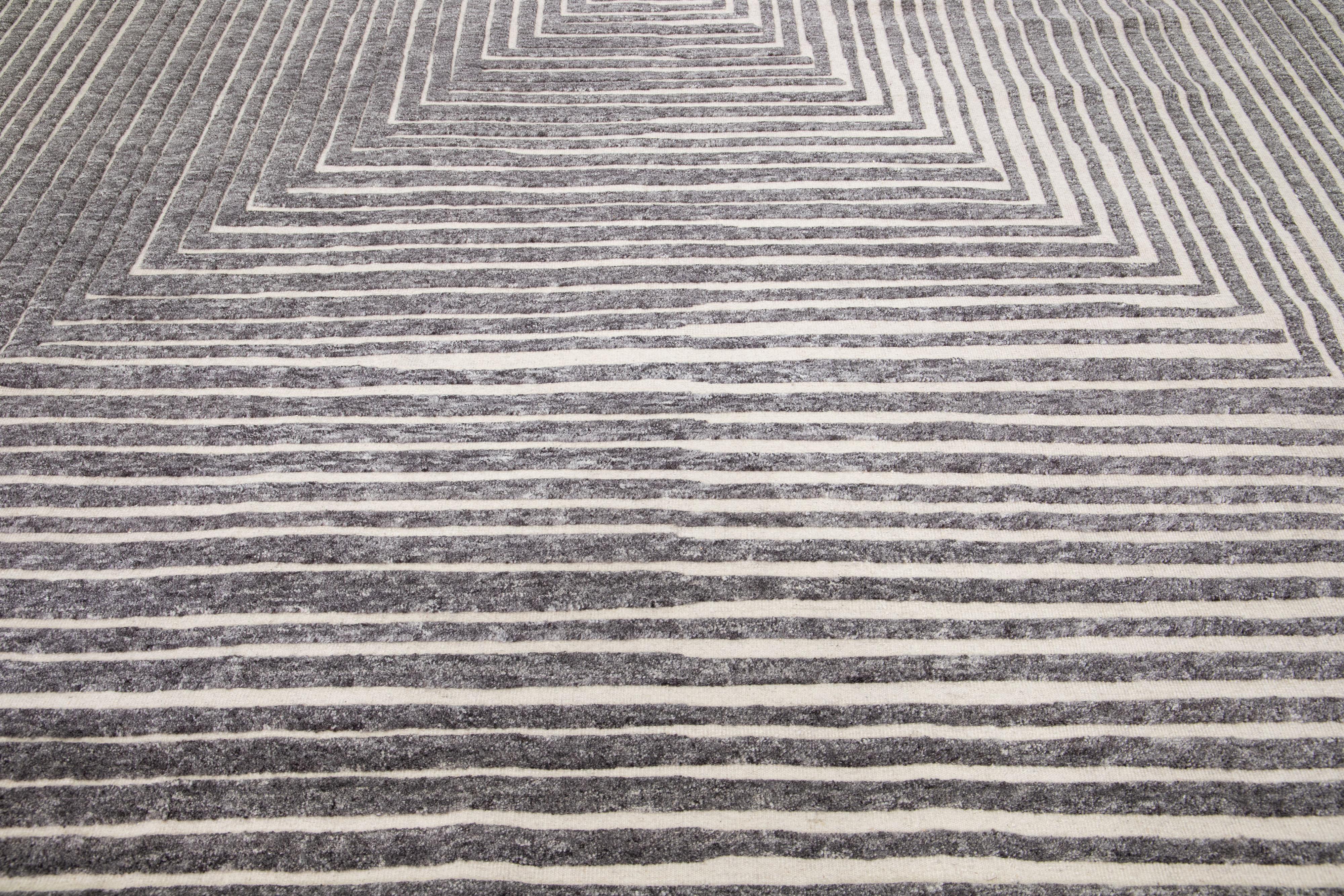 Beautiful modern Moroccan-style hand-knotted wool rug with a beige color field. This rug is part of our Apadana's Safi Collection and features an Op Art squares seamless design in gray.

This rug measures: 12'1