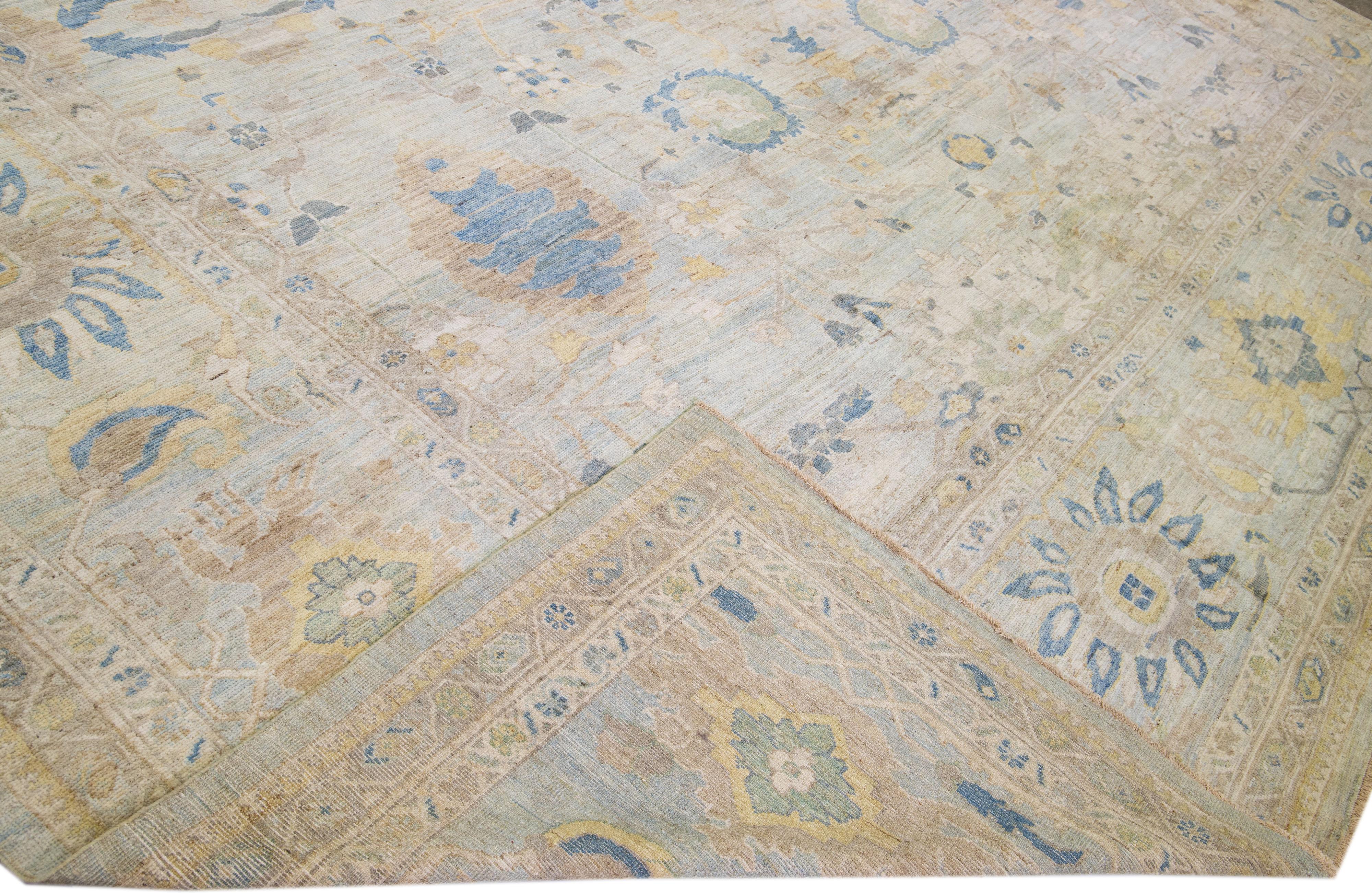 Beautiful modern Sultanabad hand-knotted oversize wool rug with a light blue color field. This rug has brown and beige accents in a gorgeous all-over floral design.

This rug measures: 16'6