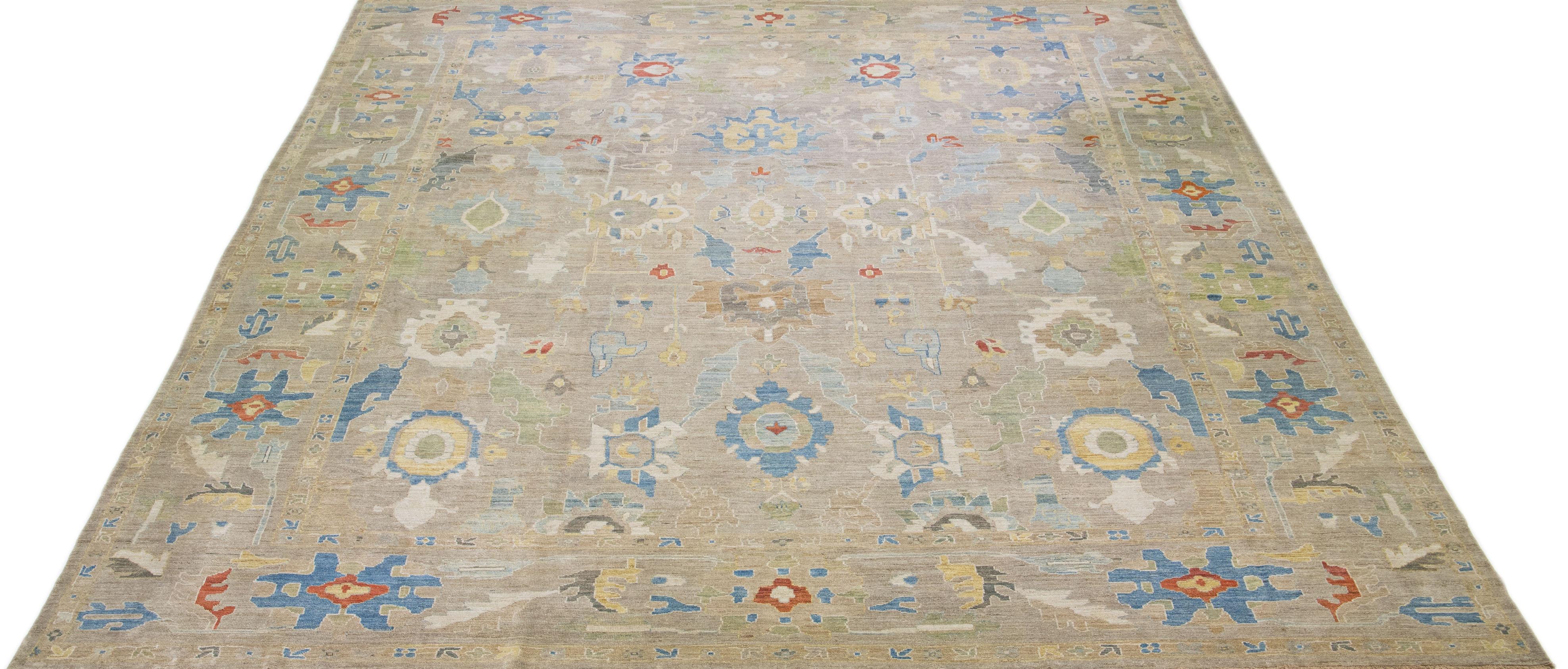 Beautiful modern sultanabad hand-knotted wool rug with a beige color field. This rug has a designed frame with multicolor accents in a gorgeous all-over floral design.

This rug measures: 16' 1