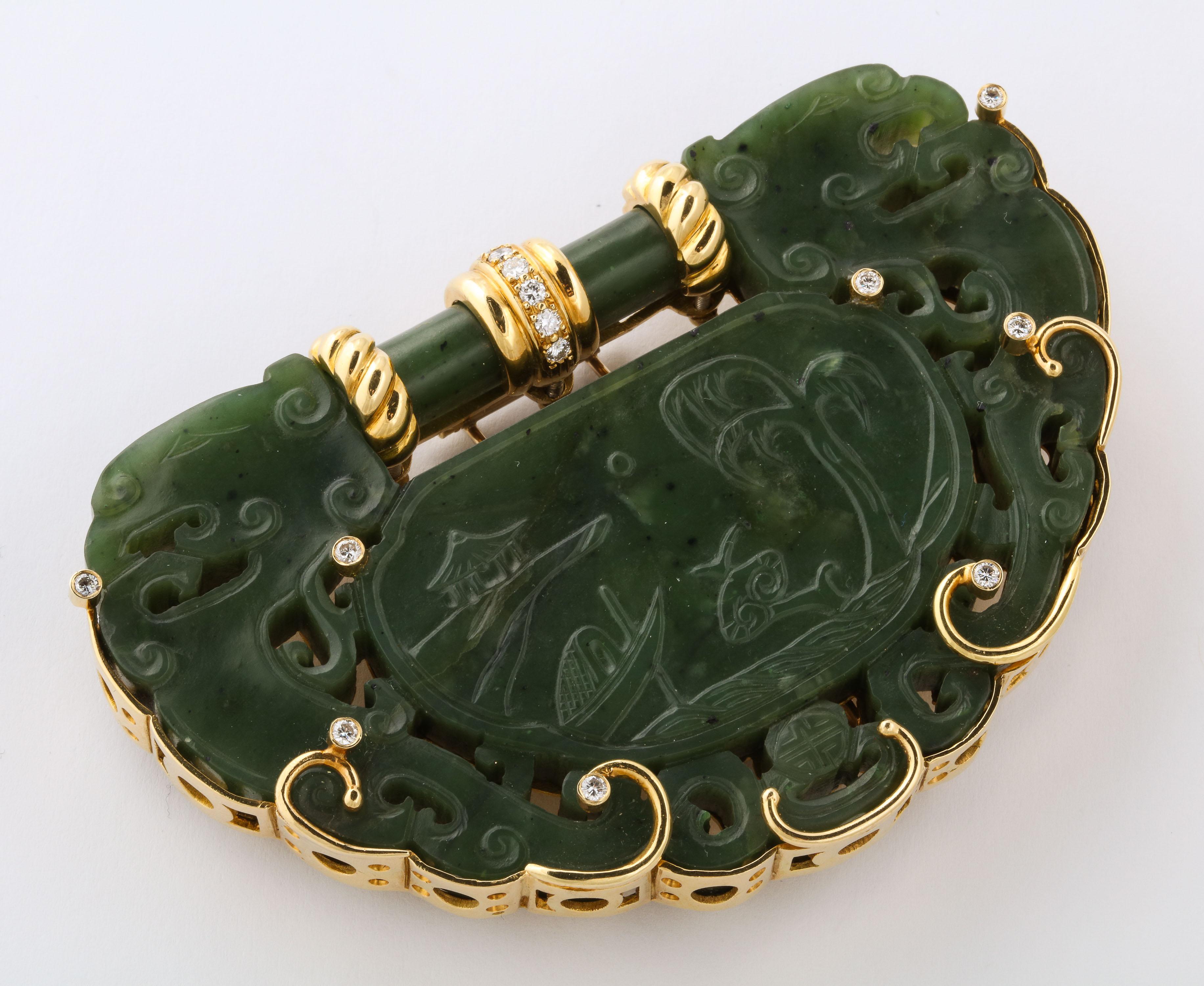 Hand made 18kt kt Yellow Gold Oversize Clip set around a Nephrite Jade Pierced and Decorated Chinese Carving which depicts a water scene with associated cloud elements.
Piece Late 18th/19thCentury.  Mounting - custom made Ca 1940/60.  Set with 2