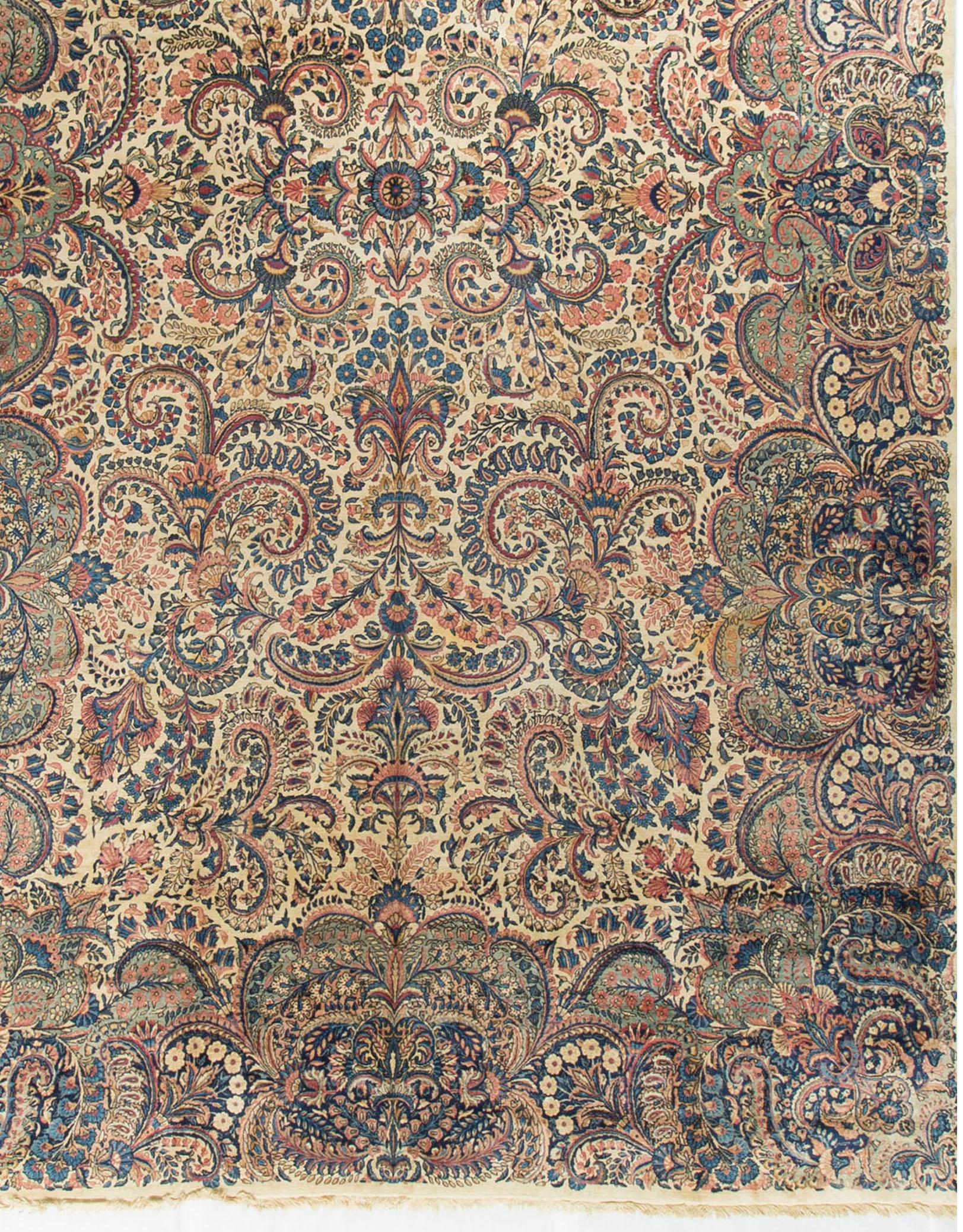 Oversize Persian Kerman rug carpet, circa 1930. A vintage, circa 1930s Kerman rug from Persia. This wonderful piece is full to overflowing with wonderful floral designs and swirls that are so synonymous with rugs from this area. The border is not of