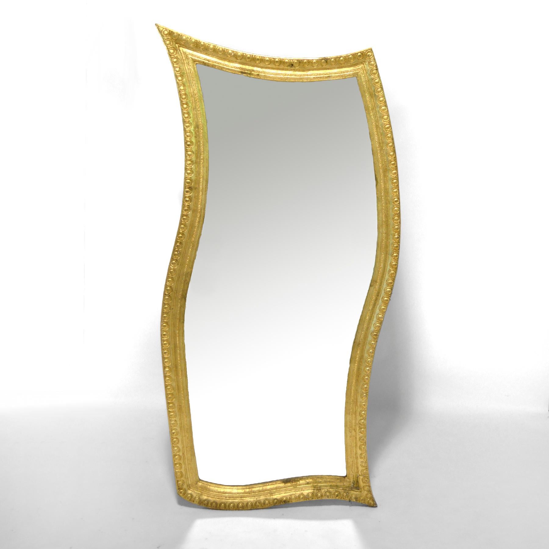 This wild and wonderful oversize mirror has a gilt frame with an exuberant shape. It can be hung either vertically or horizontally, but we particularly like it when sitting on the floor and leaning against the wall were is serves beautifully as a