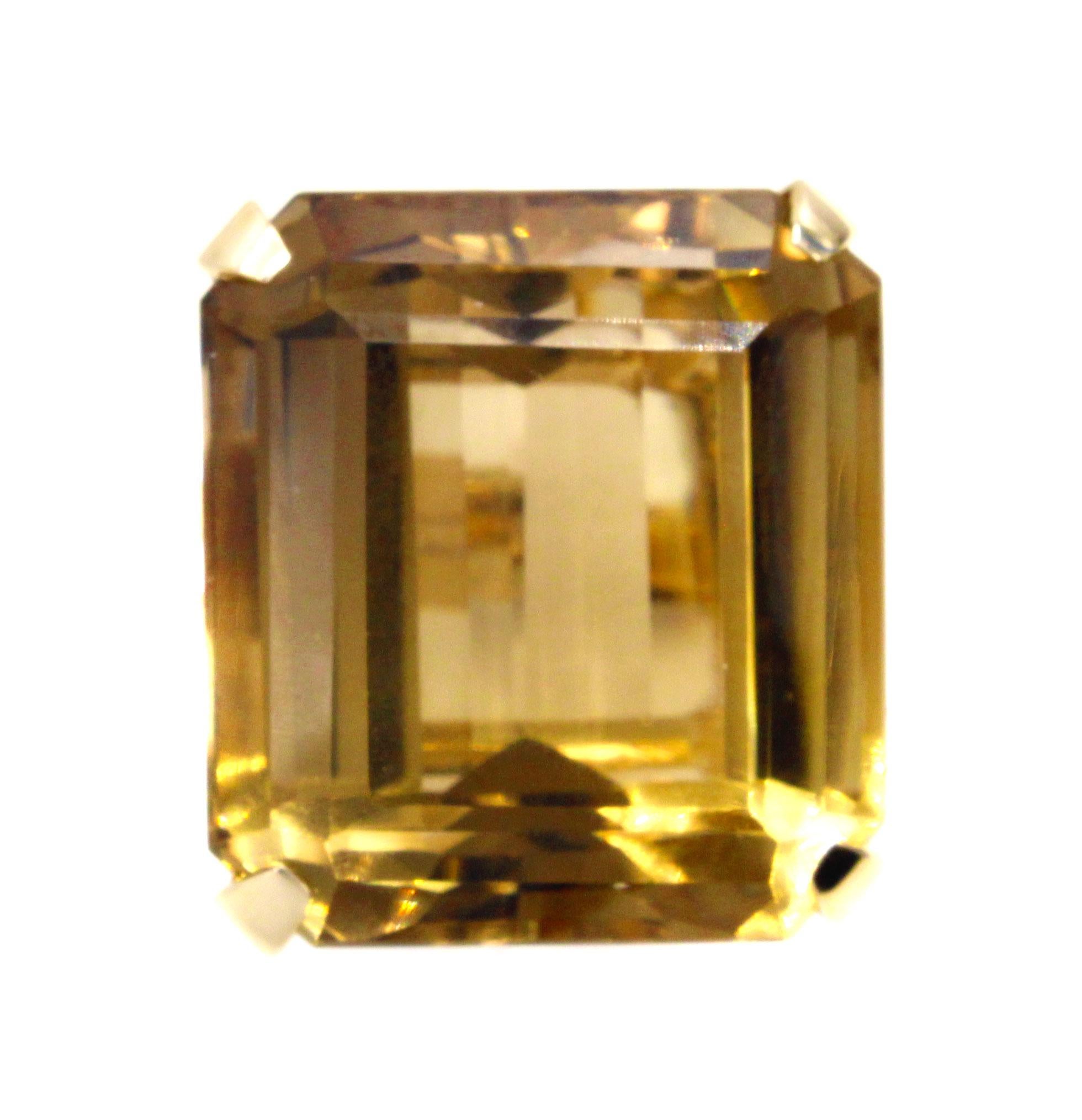 Featured in this handcrafted Retro yellow gold ring is a perfectly cut Citrine measured to weigh approximately 51 carats. The beautifully emerald cut gemstone exhibits a wonderful saturation of color and brilliance. This bold piece of jewelry is