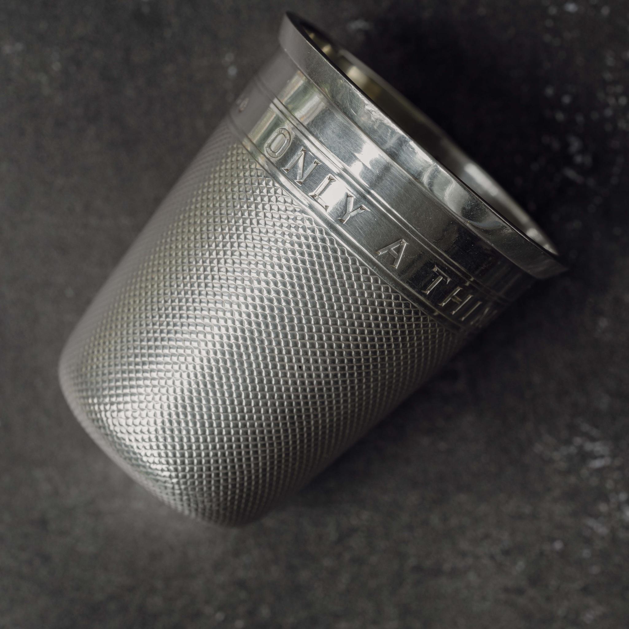 A superb silver cup modelled as an oversize thimble, with gilded interior and a nineteenth century joke ‘Only A Thimble Full’ engraved around the top of the cup. Hallmarked Birmingham 1884.

Dimensions: 5.25 cm/2? inches (height ) x 4.5 cm/1¾
