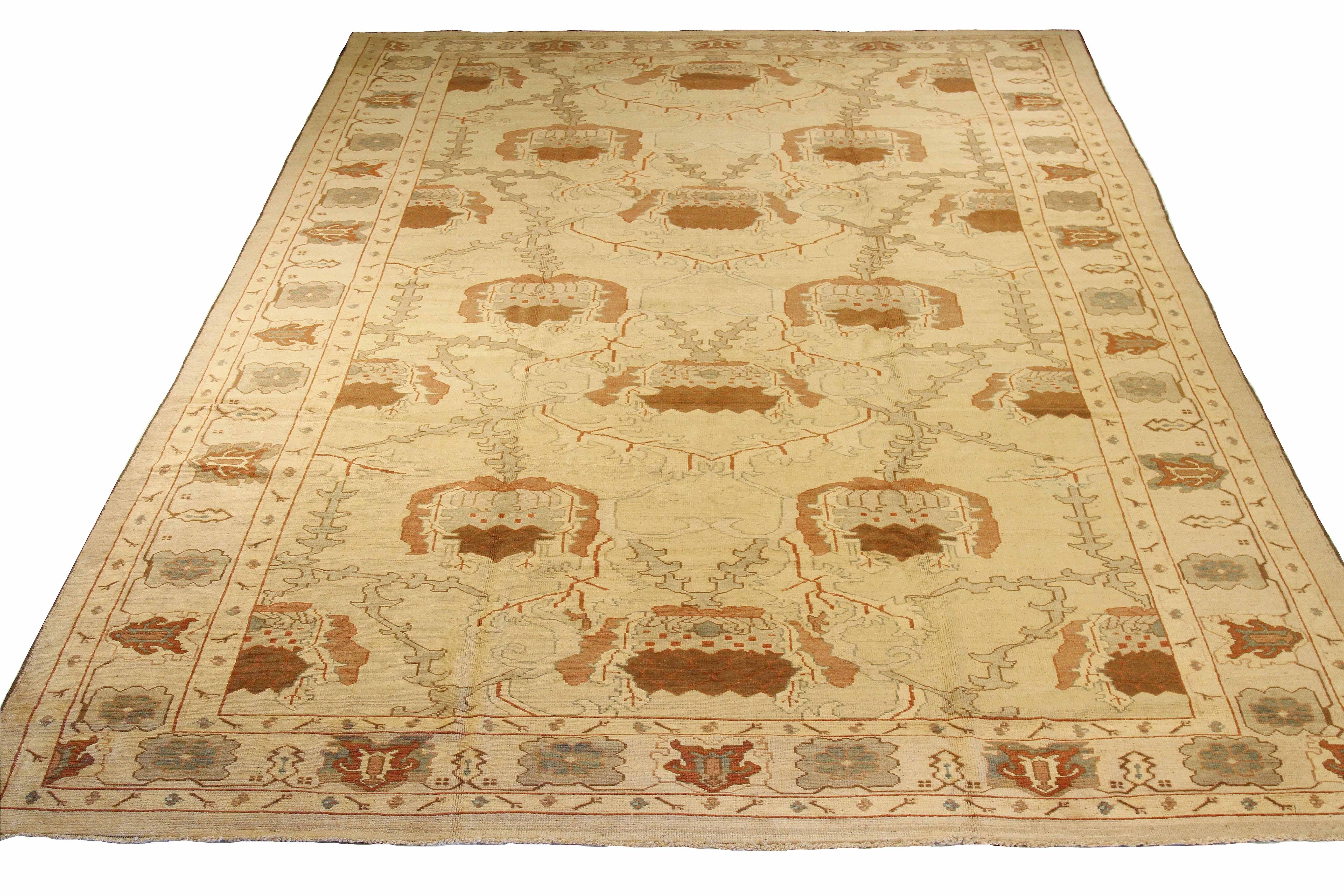 Large and oversized handmade Turkish rug from high-quality sheep’s wool and colored with eco-friendly vegetable dyes that are proven safe for humans and pets alike. It’s a Donegal design showcasing an ivory field with gray and brown botanical