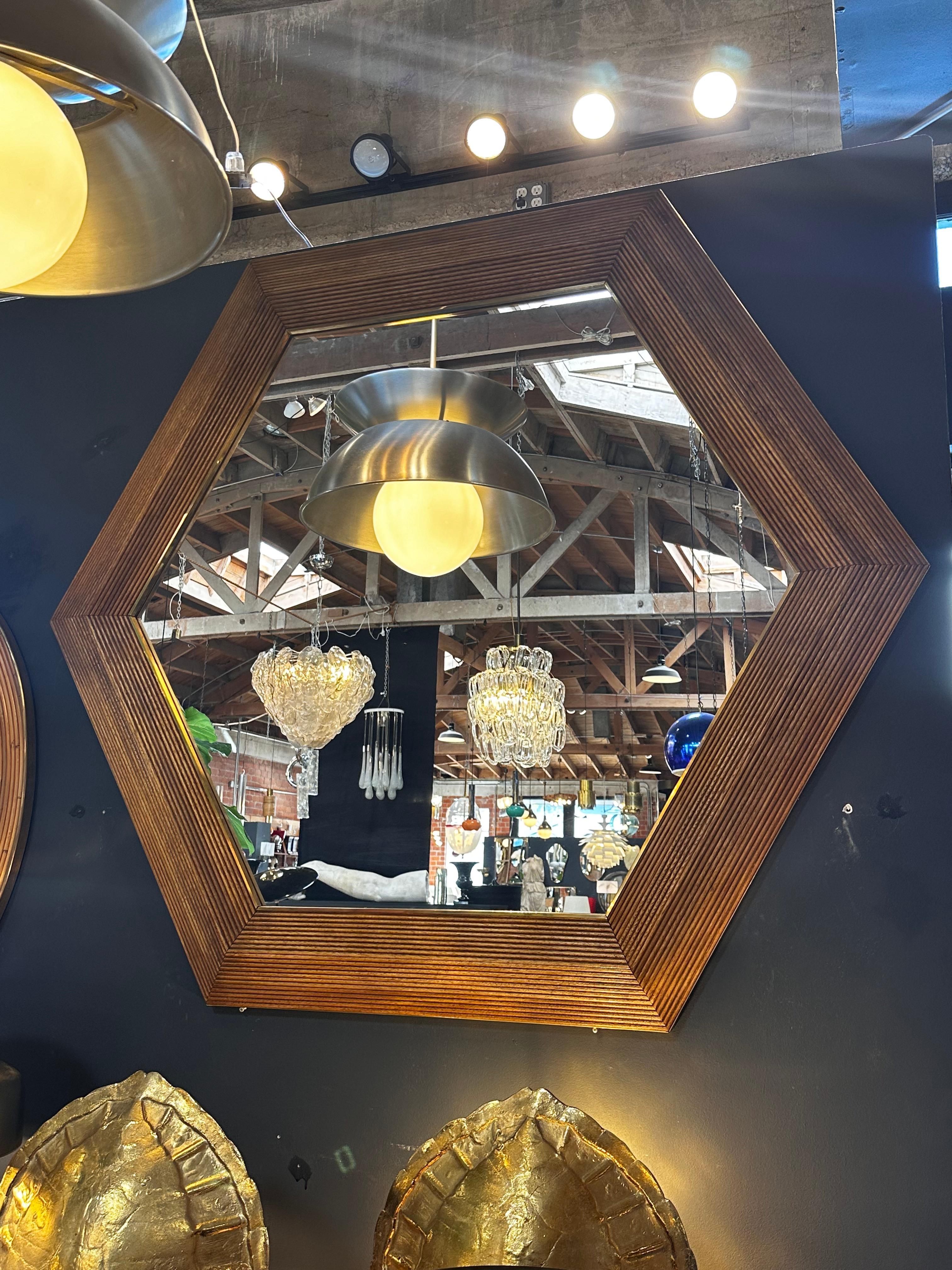 The Oversize Vintage Hexagonal Wall Mirror from the 1980s is a statement piece characterized by its large hexagonal shape. This mirror, reflecting the design trends of the 1980s, features bold proportions and often incorporates a mix of materials in