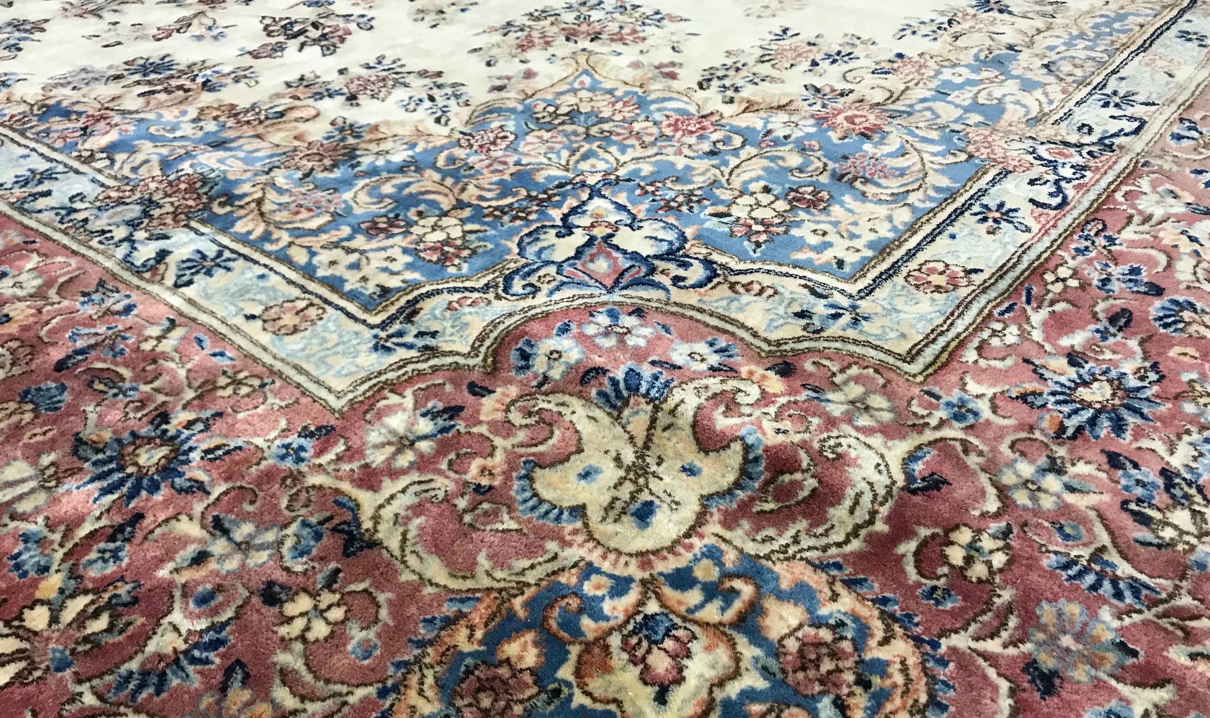 Oversize vintage Persian Kerman rug circa 1940. A palace size Kerman rug with the field overflowing with floral elements in a wide variety of colors and shades all centered on a small medallion with the border continuing the meticulously detailed