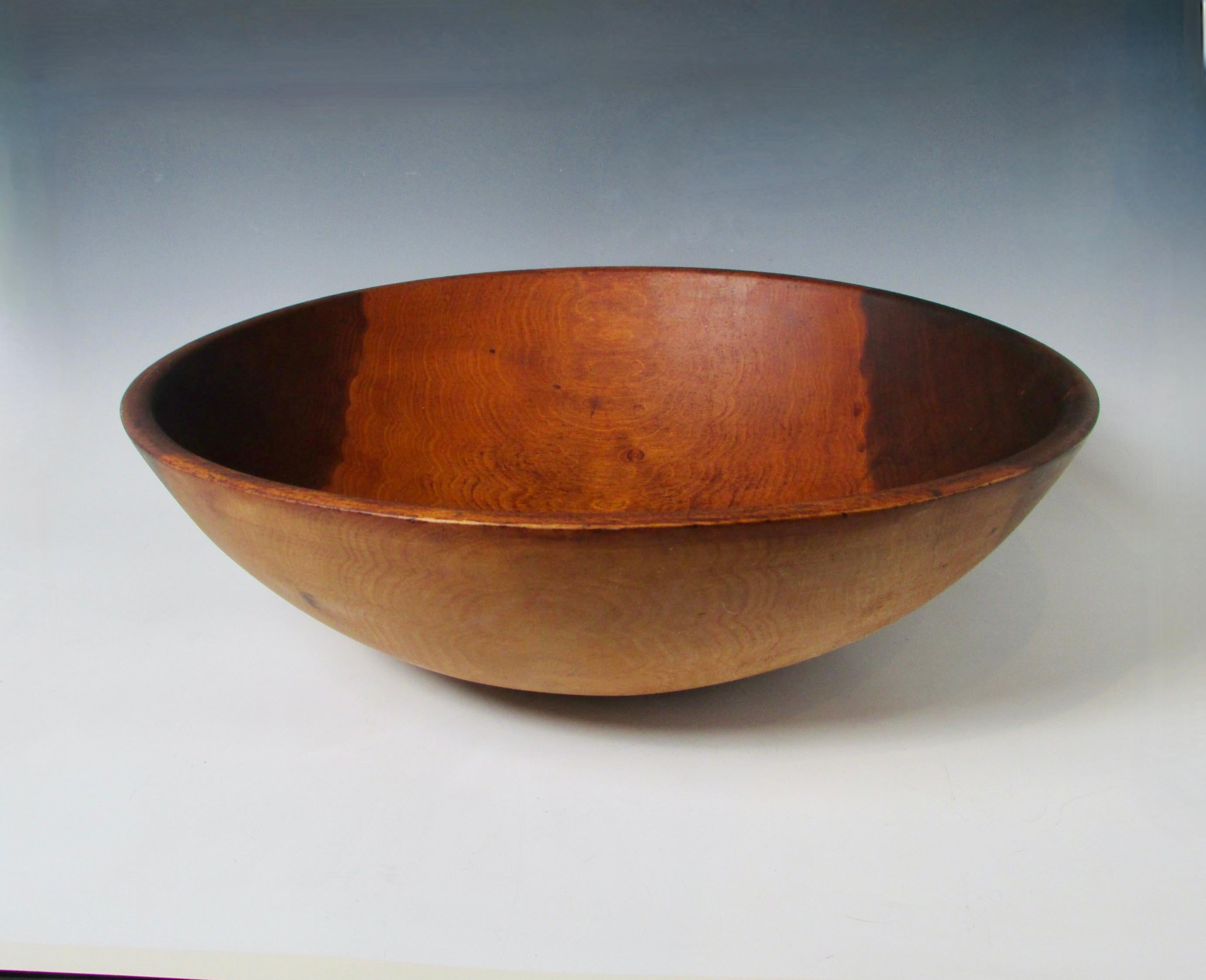 Large bowl with light sap wood and dark edges. Excellent accent for modern design interiors. Flowers gourds glass objects all show well in this organic form.