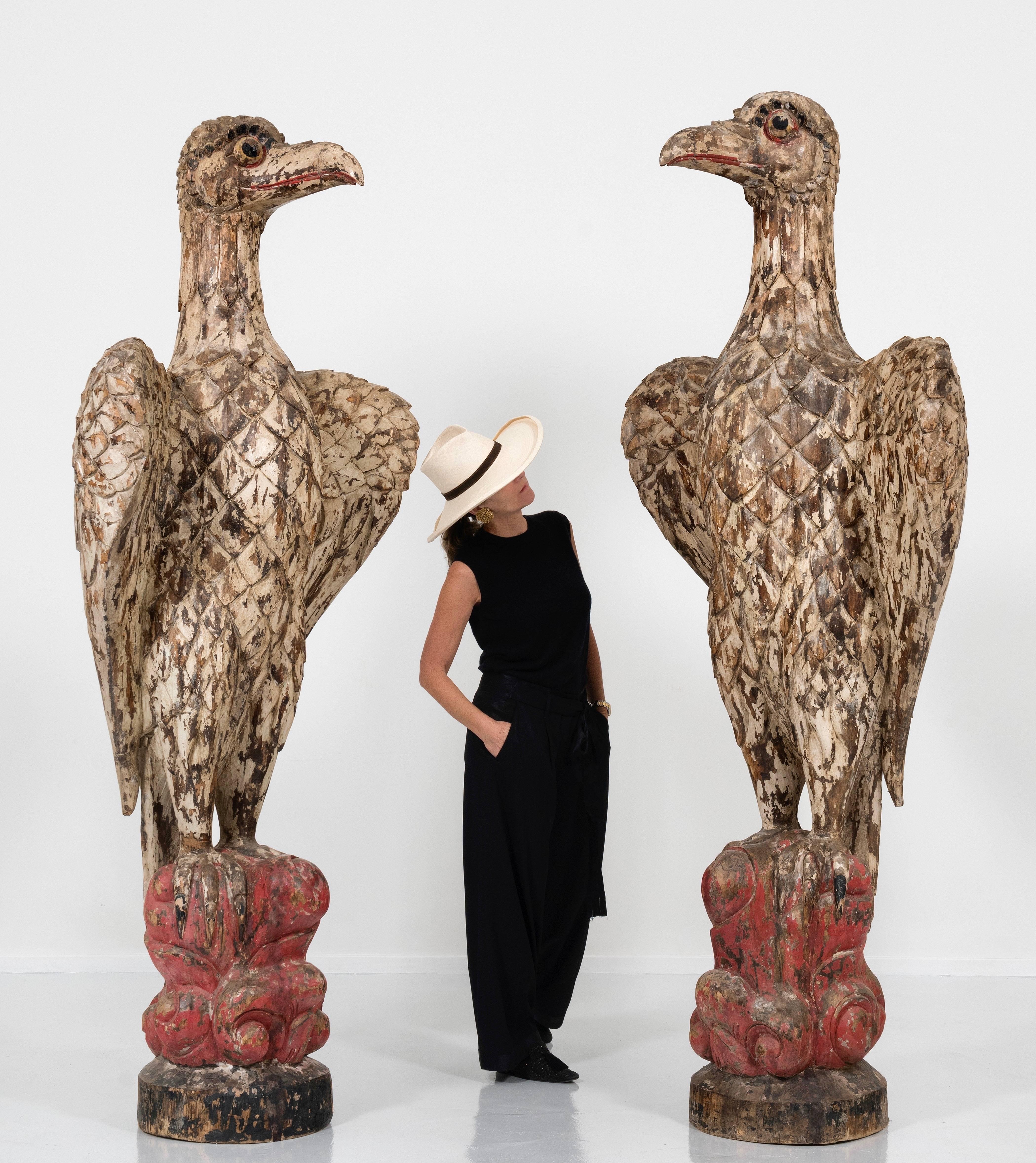 Monumental rare pair of eagles of 100 inches Height.
Carved wood, formerly polychromed, base in stylized motives. 
Beautiful age patine. 
Spectacular.
Creates a spectacular decor.
