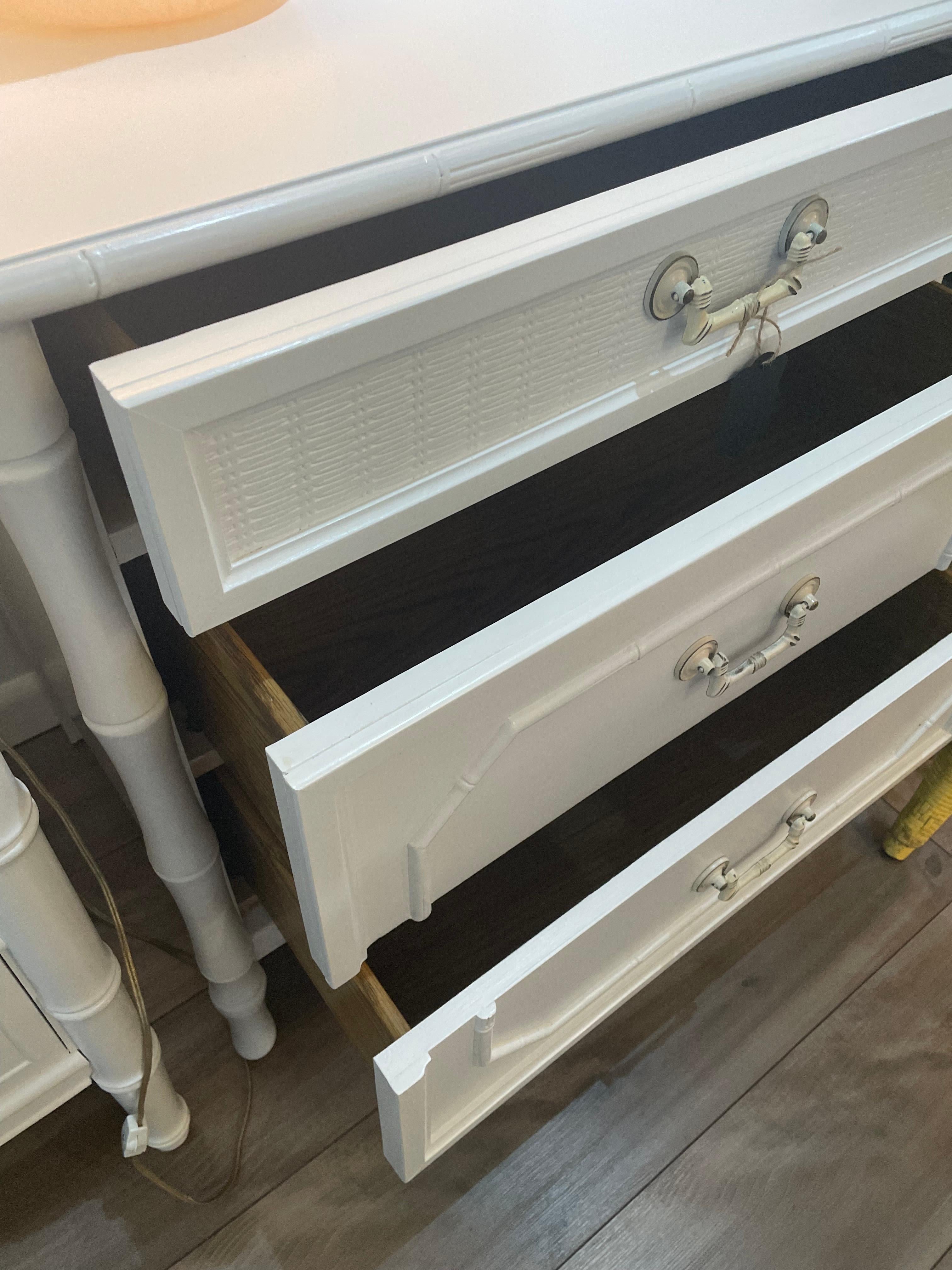 Oversized, vintage faux bamboo three drawer chest by Broyhill Furniture. Highly sought after rare size that is perfect for small spaces or tall enough for a nightstand. Has been repainted beautifully in white. Dovetailed joints and drawers this