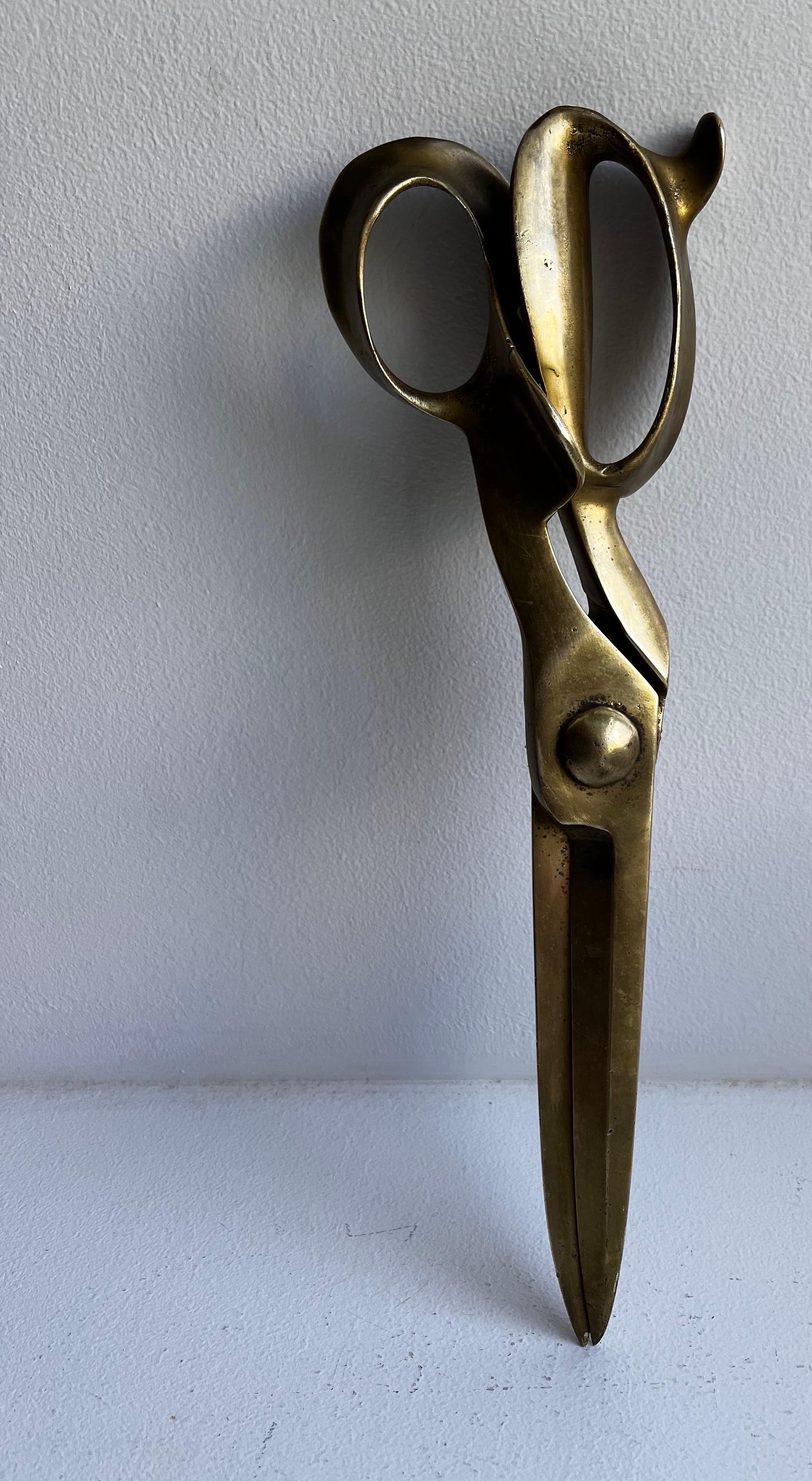 Brass oversized scissors 
probably used for advertising and or store display.
These will add interest to any room, wall, hair salon or fashion fashion boutique.