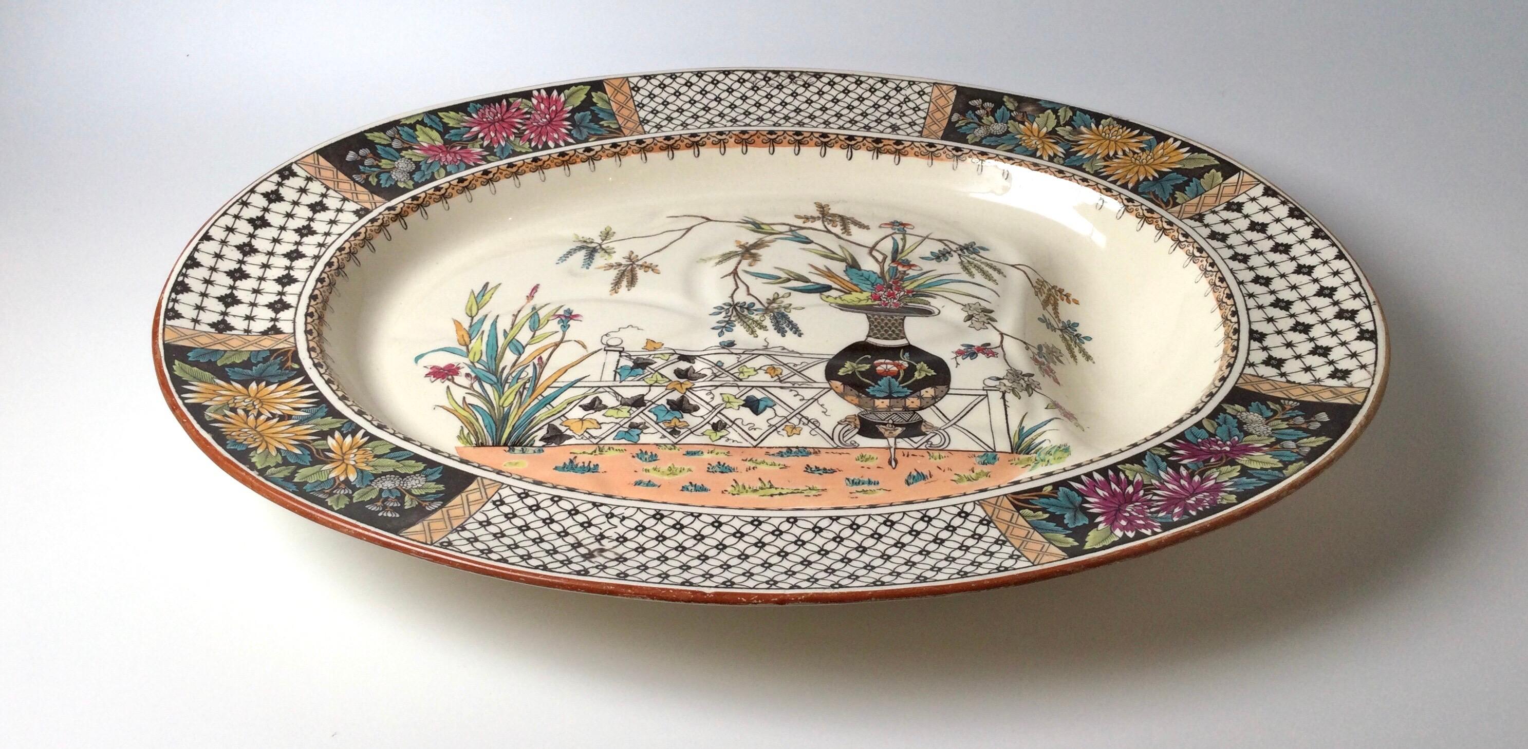 Oversized Copland England Aesthetic period footed meat platter in the Chrysanthemum design. Drainage indentation leads to a deep gravy well. 21 by 17
