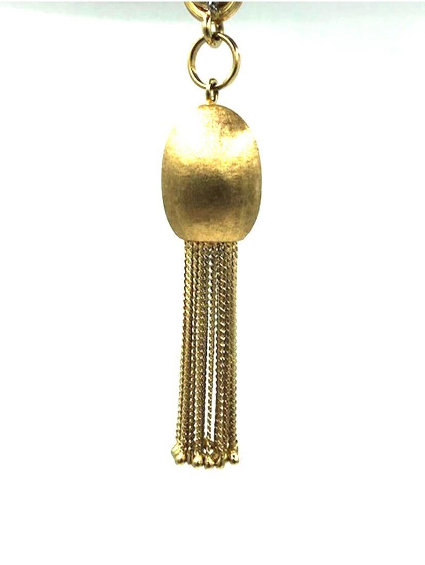 This larger than life,  very heavy and spectacular rope necklace terminates at both ends with beautiful brushed gold bobble tassels. The fringe on the tassels is made of fine strands of gold that finish beautifully into tiny balls. This amazing