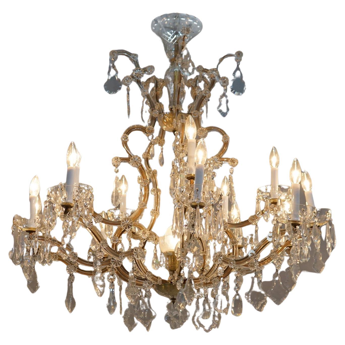 ***Ask About Reduced In-House Shipping Rates - Reliable Service & Fully Insured***
An antique French Louis XIV style chandelier offers scroll form frame with arms terminating in candle lights and cut crystals throughout, c1930

Measures- 71''H x