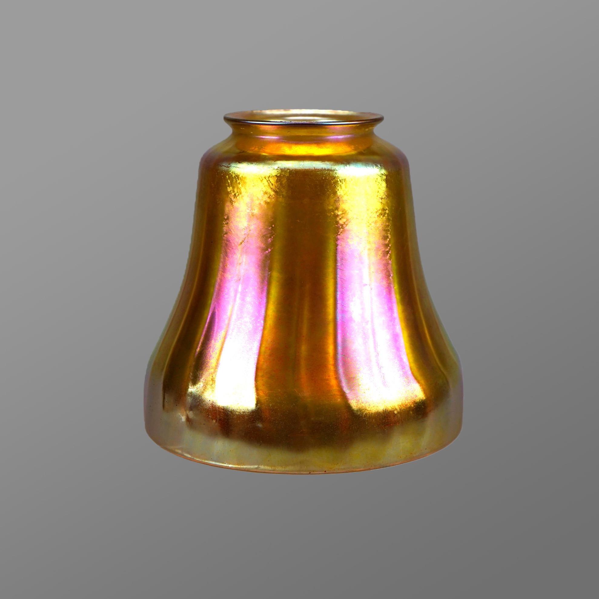 A large antique Arts and Crafts light shade by Steuben offers gold aurene art glass construction in bell form, unsigned, c1920

Measures- 6.5'' H x 6.25'' W x 6.25'' D.

Catalogue Note: Ask about DISCOUNTED DELIVERY RATES available to most regions