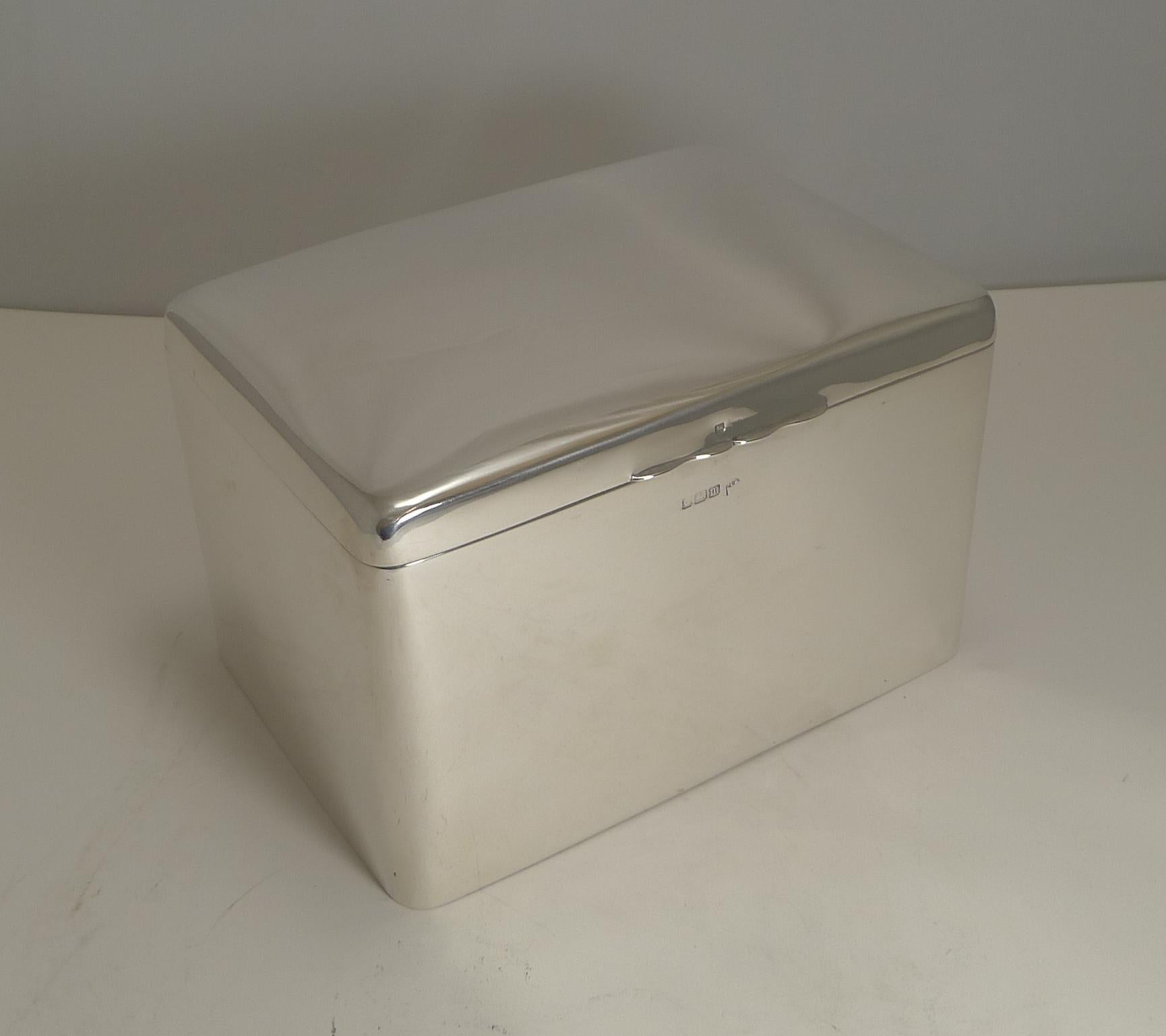 A stunning and unusual large cigar box / Humidor made from sterling silver by the top-notch silversmith, Walker and Hall.

A fabulous simple Art Deco design with a pillow top, the hinged lid lifts to reveal the underside of the lid lavishly