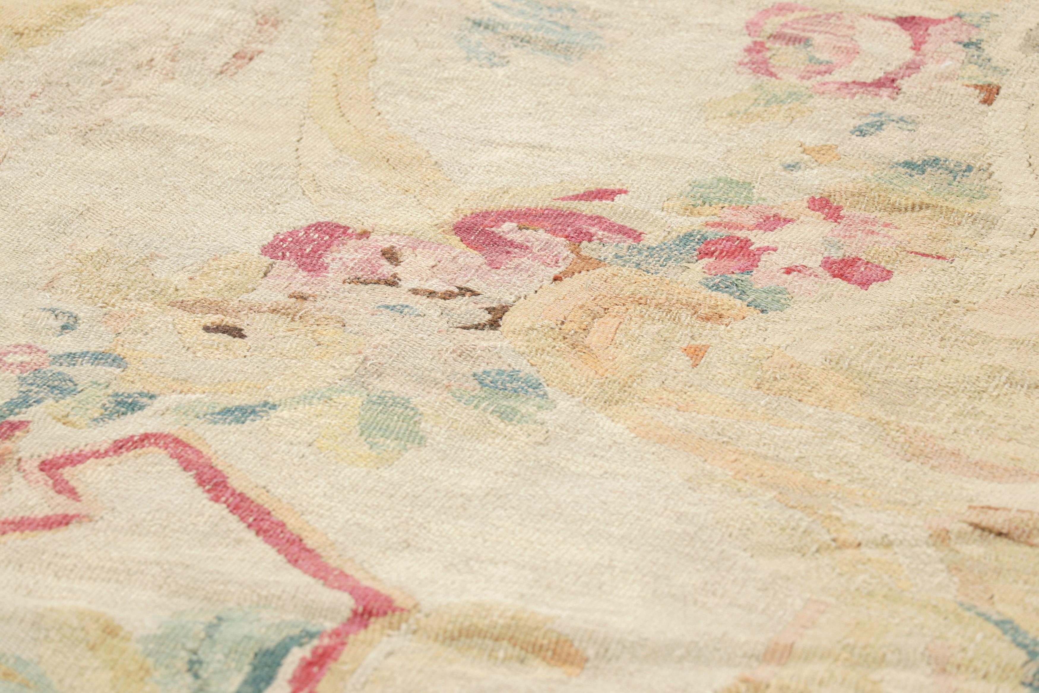 Handwoven in wool, this 16x18 antique oversized Aubusson rug originating from France, holds both aesthetic and historical value, suitable for institutional collections, period interiors, or collectors seeking significant examples of 18th-century