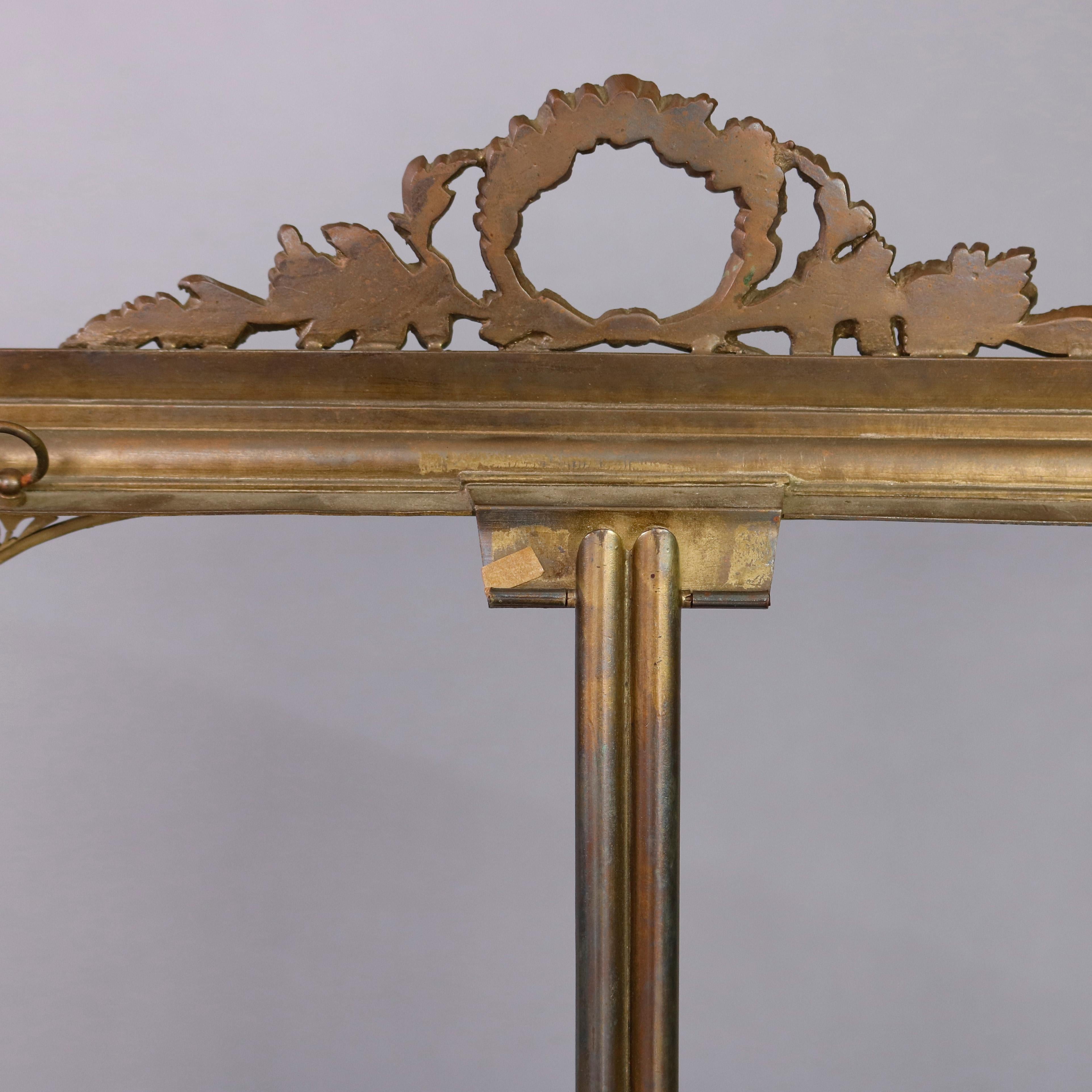An antique and oversized French neoclassical picture frame offers bronze construction with pierced foliate wreath crest and pierced corbels, back support, circa 1910.

Measures: 21