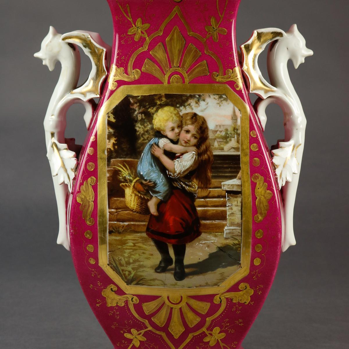 An oversized antique French Old Paris porcelain vase offers hourglass form with central hand painted reserve of children, flanked by figural dragon handles, surmounted by flared and scalloped mouth and raised on flared foot, gilt highlights