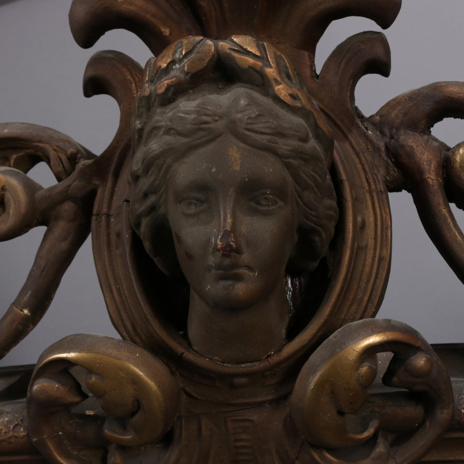 Oversized antique French Classical over mantle mirror features arched form with pierced scroll and foliate crest having central Jenny Lind mask, base flanked with pierced scroll work, early 20th century

Measures: 63.5