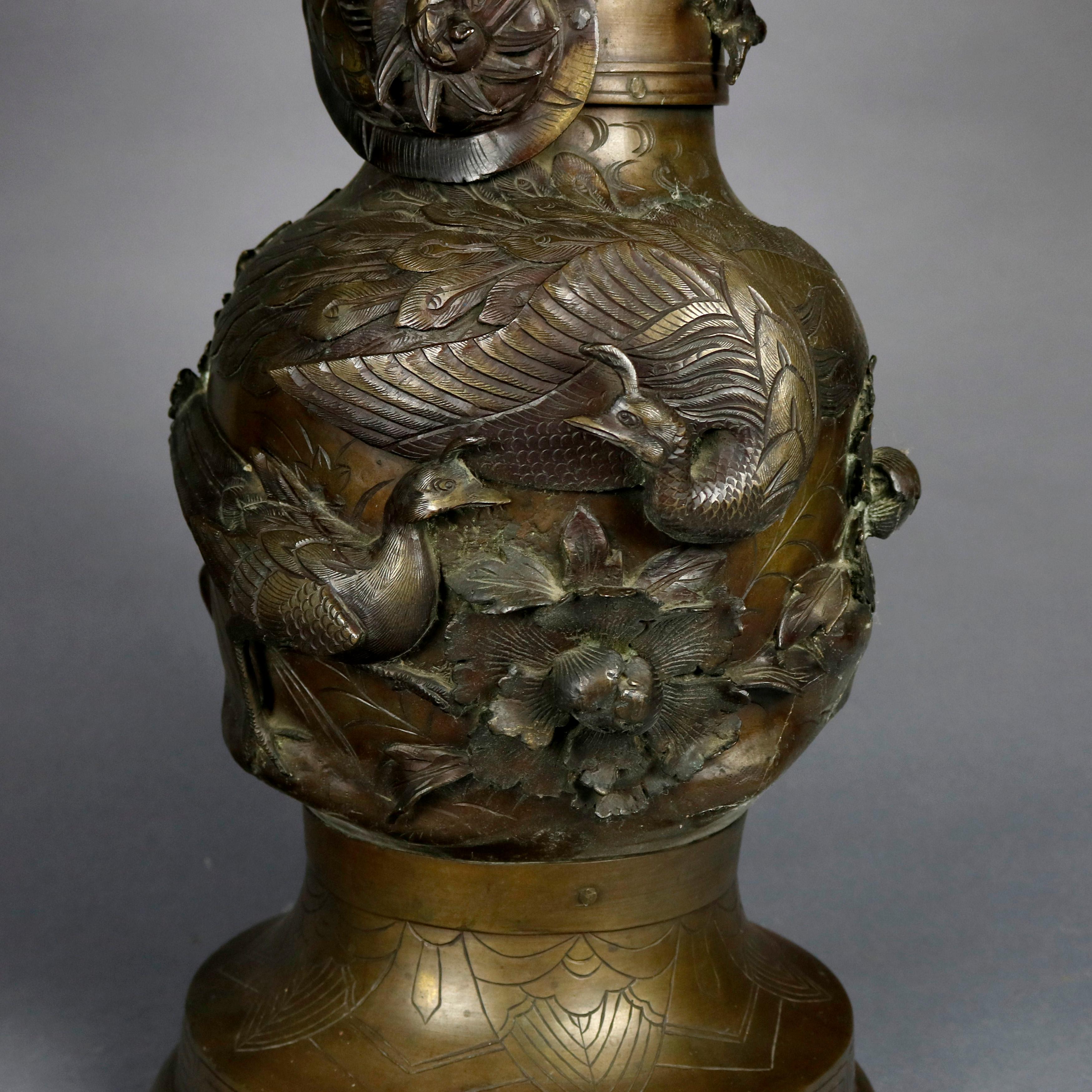 An oversized antique floor vase offers bronze floor vase offers urn form with all-over high relief garden scene with flowers, birds, and dragon on neck, incised Greek Key pattern on collar and base, circa 1920

***DELIVERY NOTICE – Due to COVID-19