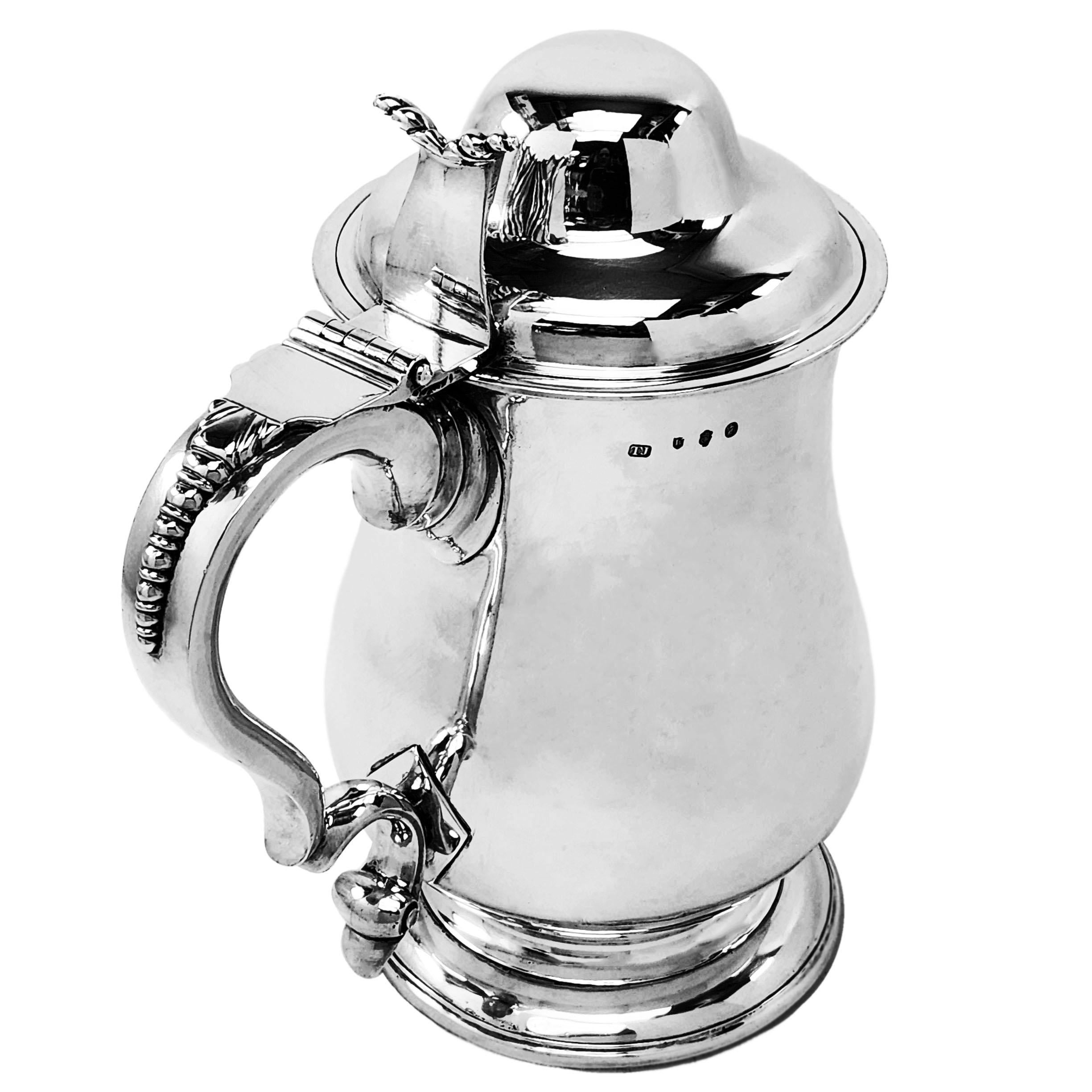 An impressive Antique Irish Silver Tankard in a classic baluster shape with a substantial domed lid. The Lidded Beer Tankard has a large crest engraved opposite the equally large scroll handle. This Tankard is of notably large size.

Made in Dublin,
