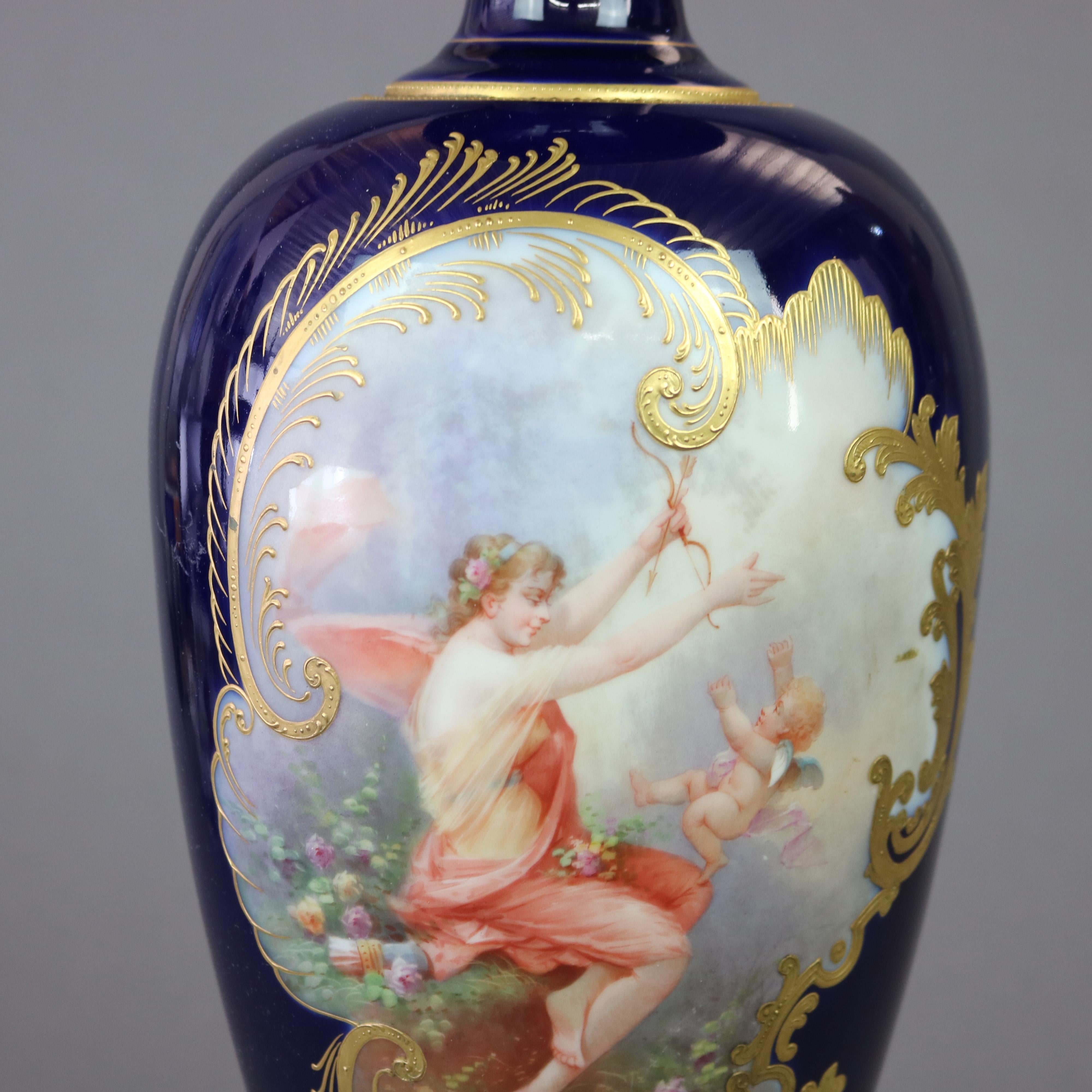 A large French Limoges urn offers porcelain construction with hand painted allegorical reserve with woman and cherub on cobalt blue ground, gilt highlights throughout, maker mark on base as photographed, c1900

Measures - 21.25
