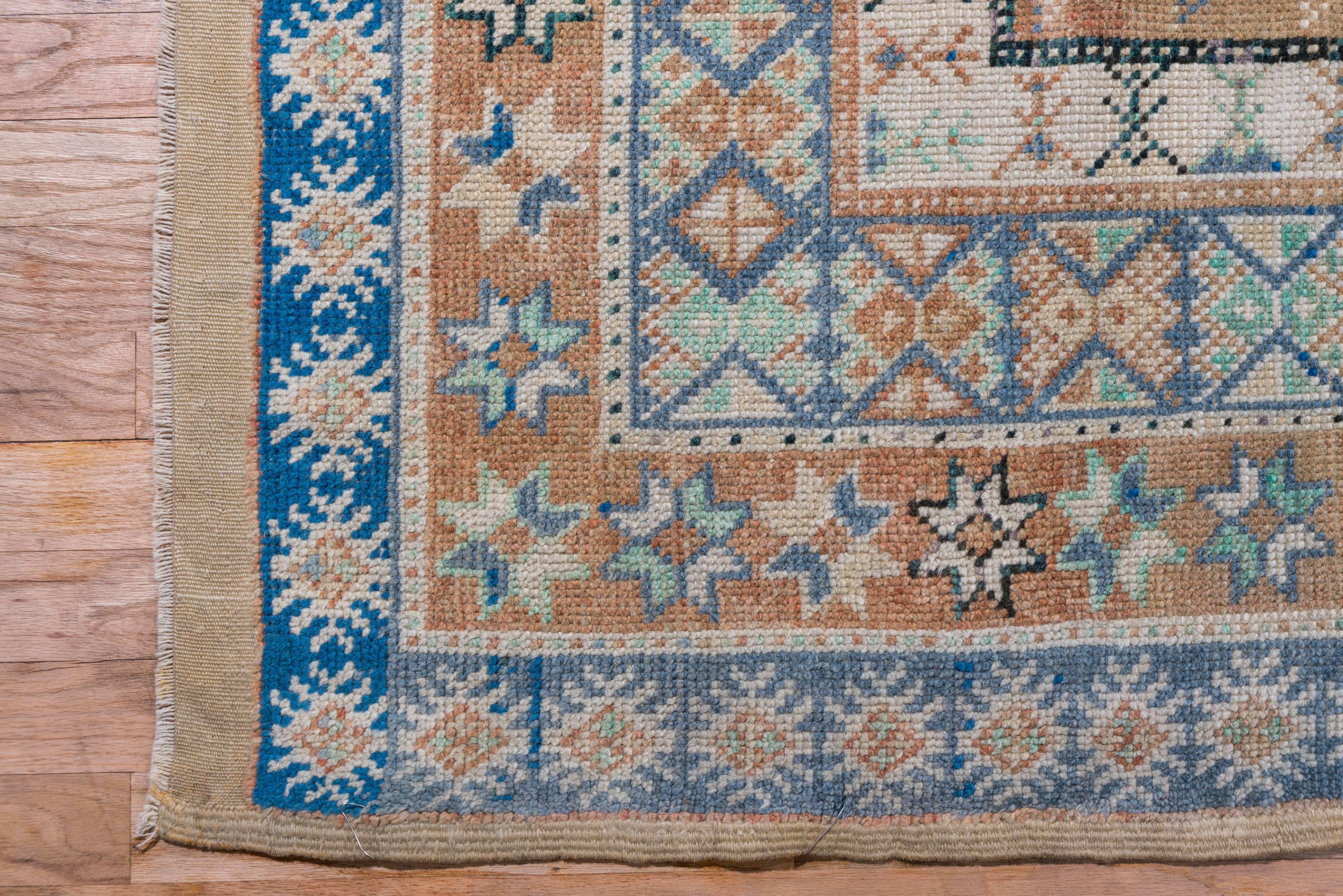 This very unusual 1920s Moroccan rug is not what is entirely different than the typical bold and naively drawn Moroccan rug. It has three large-scale boxed compartments in the center with bold balanced colors perfectly offset by the delicately
