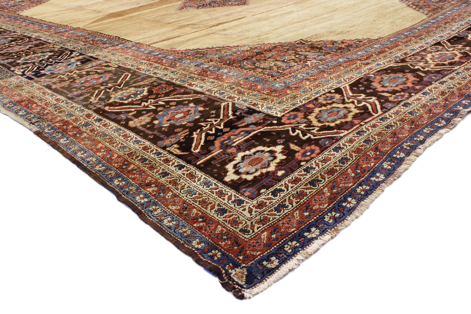 73055 Oversized Antique Persian Bakshaish Rug, 14'06 x 19'00. 
Rich in color with beguiling beauty, this hand knotted wool oversized antique Persian Bakshaish rug will take on a curated lived-in look that feels timeless while imparting a sense of