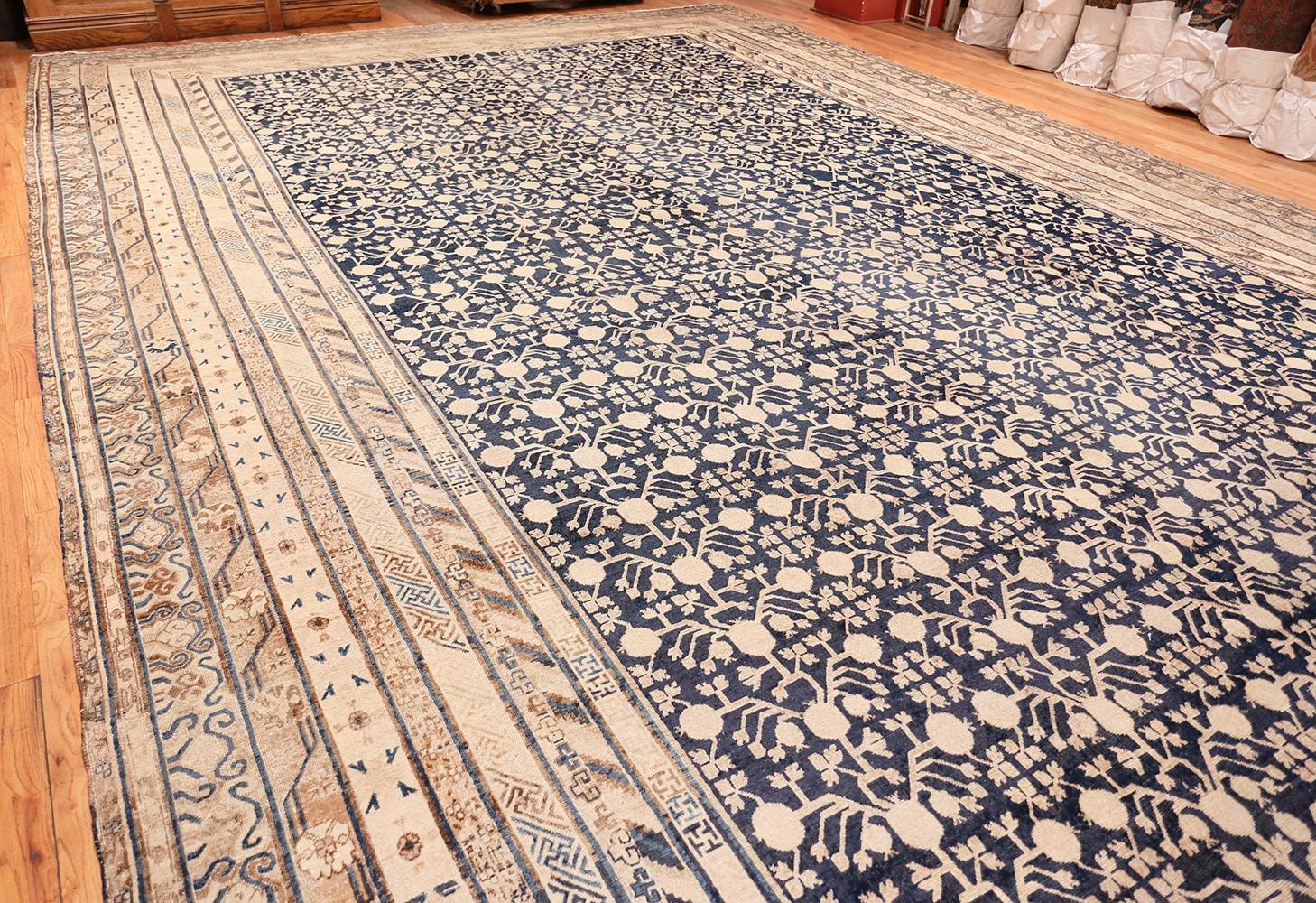 Very Rare and Breathtakingly Beautiful Oversized Antique Pomegranate Design Khotan Rug, Country of Origin: East Turkestan, Circa Date: 1900. Size: 16 ft x 24 ft 6 in (4.88 m x 7.47 m)

The high contrast ground of this exquisite antique East