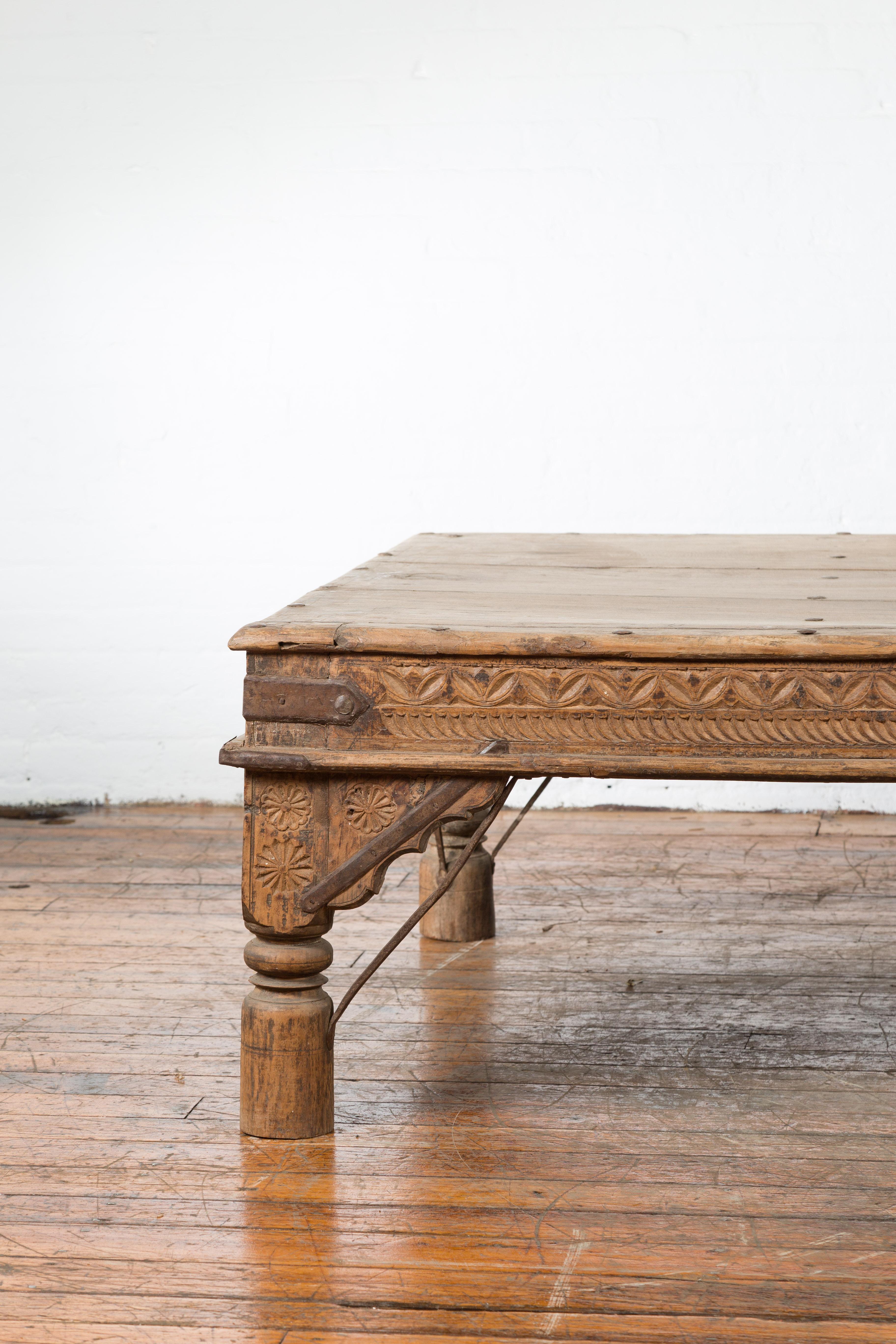 Oversized Antique Temple Door with Studs Made into a Carved Coffee Table In Good Condition In Yonkers, NY