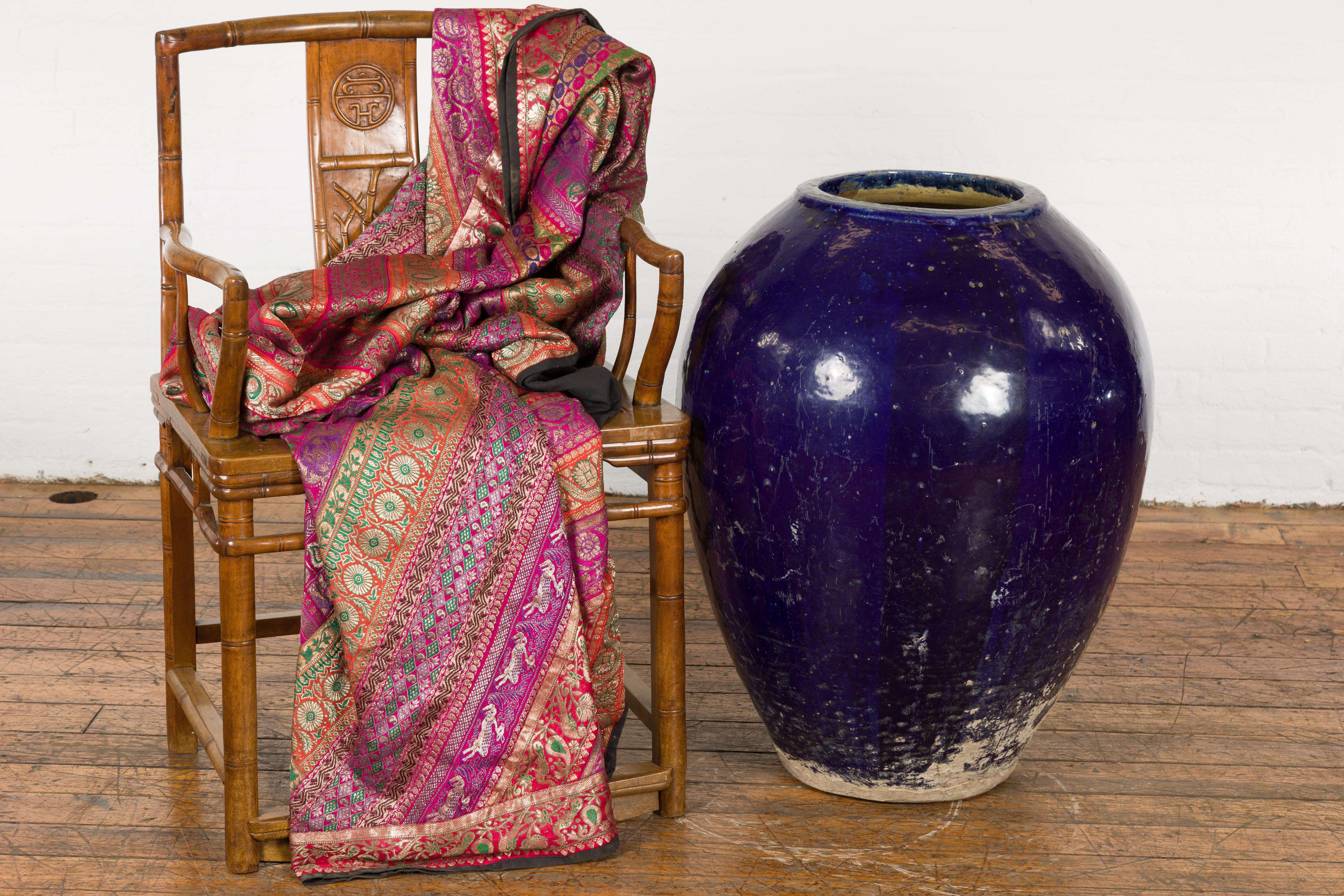 An oversized antique Thai water vessel from the early 20th century, with cobalt blue glaze, tapering lines and nicely weathered patina. Created in Thailand during the early years of the 20th century, this oversized water vessel features a circular