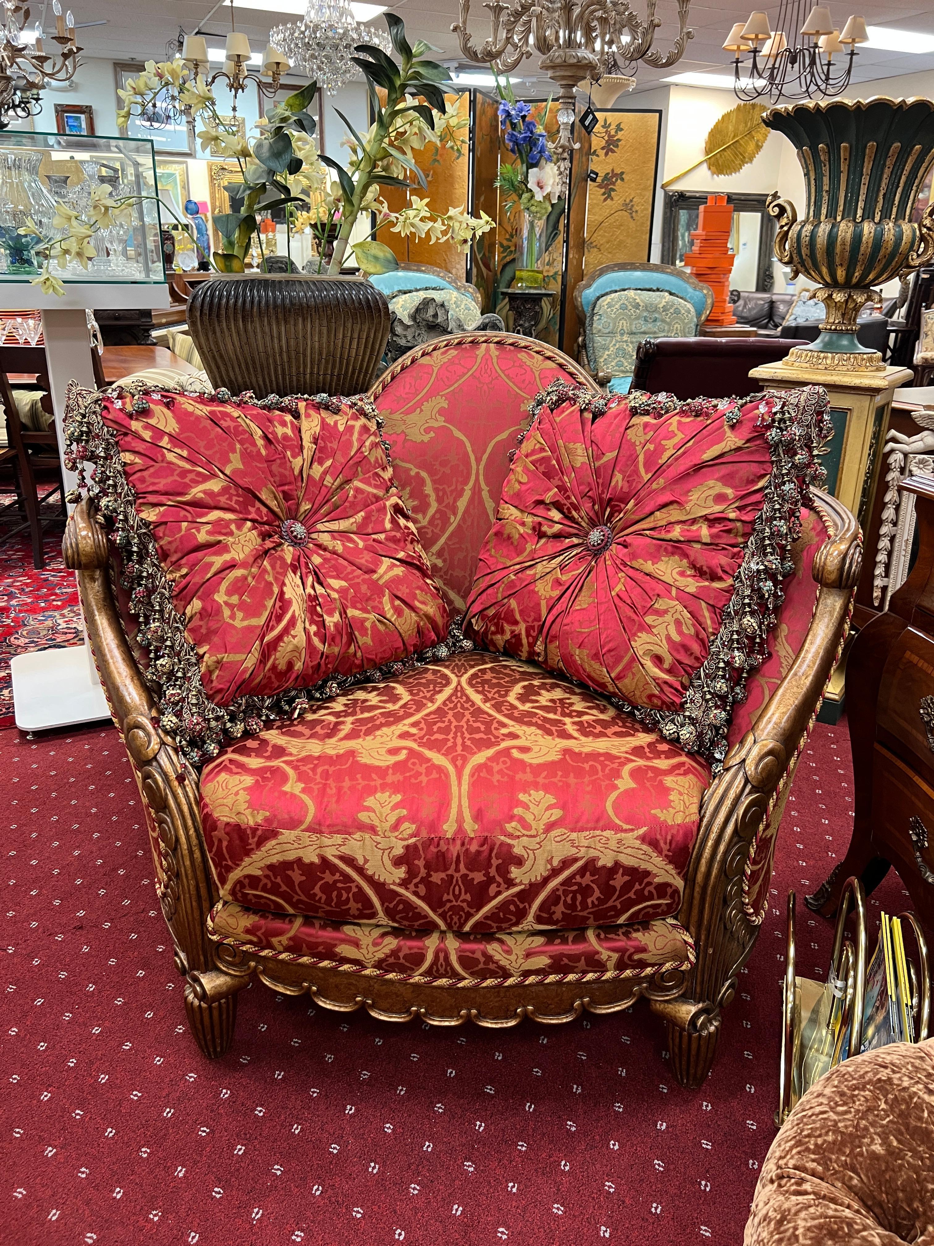 An amazing oversized lounge chair by Tomlinson, upholstered in a pinkish-red damask fabric. The custom-made pillows are included, as shown. The pillow's intricate trim work showcases attention to detail and adds the finishing touch. The chair will
