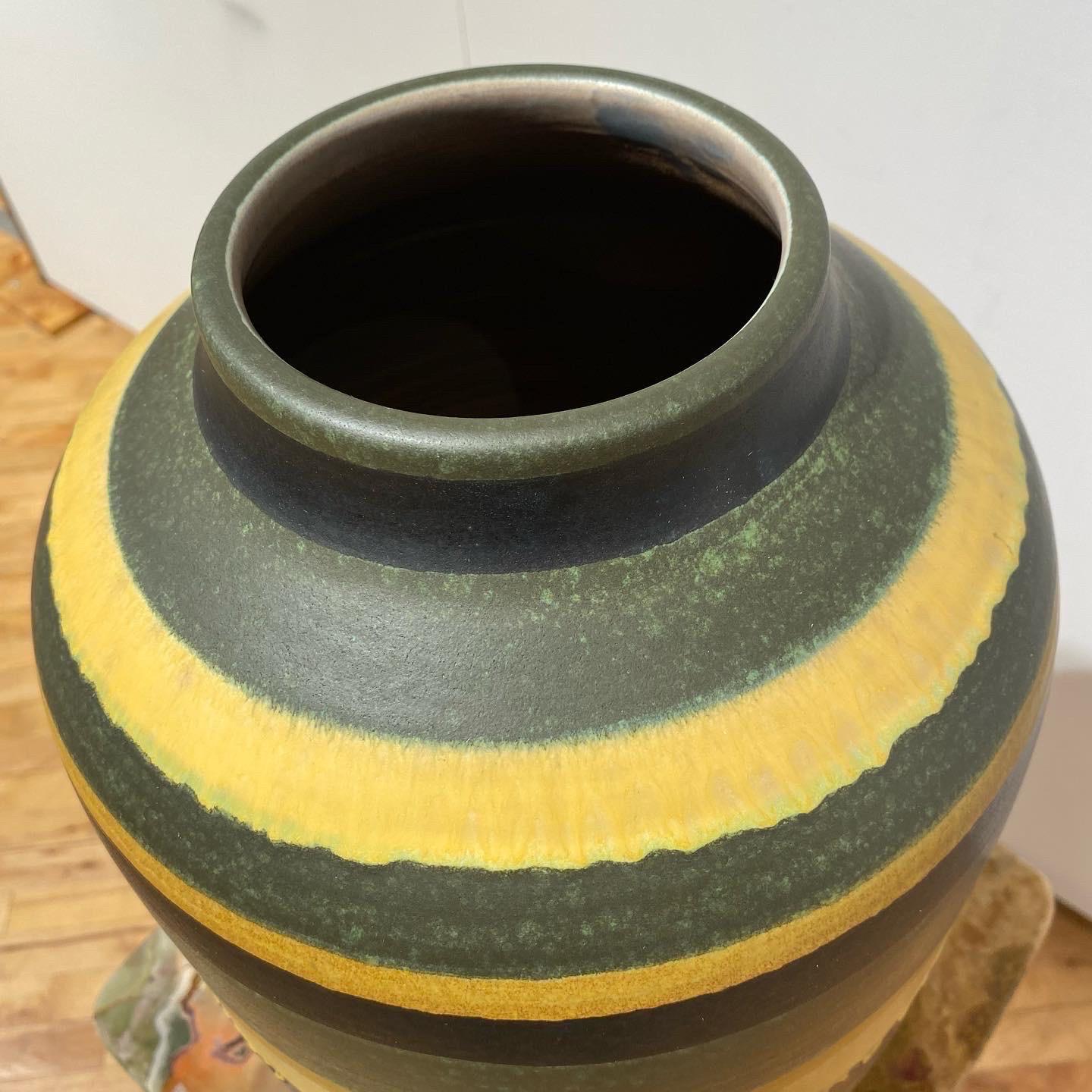 This large wheel thrown vase speaks for itself multi colored glaze and oversized. The opening is 4.5