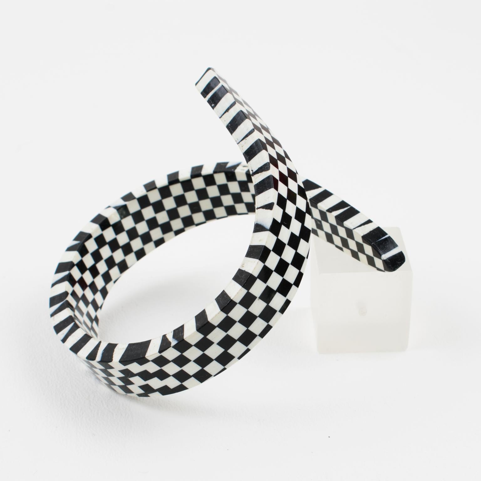 Stunning 1960s Space Age oversized sculptural Lucite bracelet bangle. Chunky coiled wrapped shape with black and white checkerboard pattern. No visible maker's mark.
Measurements: inside across is 2.50 in. diameter (6.4 cm) - width ranges from 0.63
