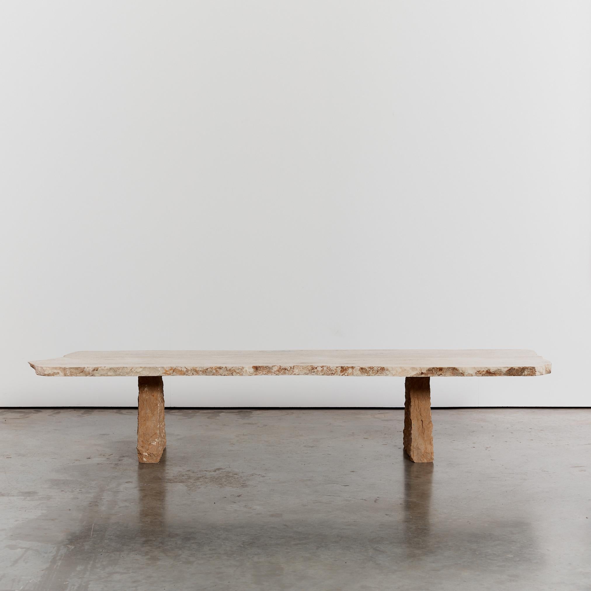 This oversized brutalist coffee table is made from a slab of extremely heavy travertine with a raw edge and chiseled stone trapeze shaped feet. Rare in both size and form, this piece was found in Spain.

Period: 1970's

Material: