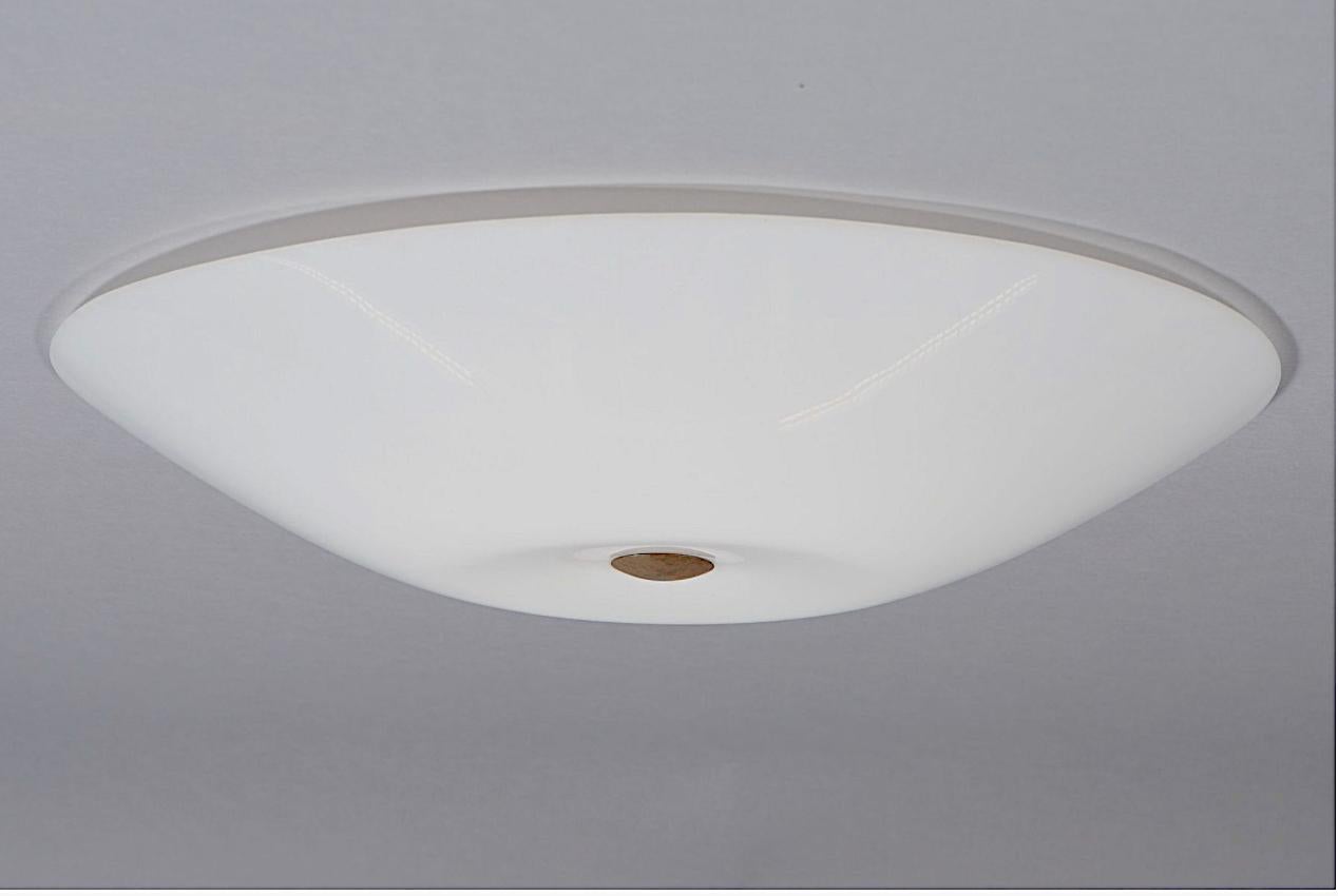 Oversized flush mount ceiling light designed by Lisa Johansson-Pape for Orno, Finland. Circa 1960th.
Acrylic shade with brass fittings and spacers. Diam- 27.5