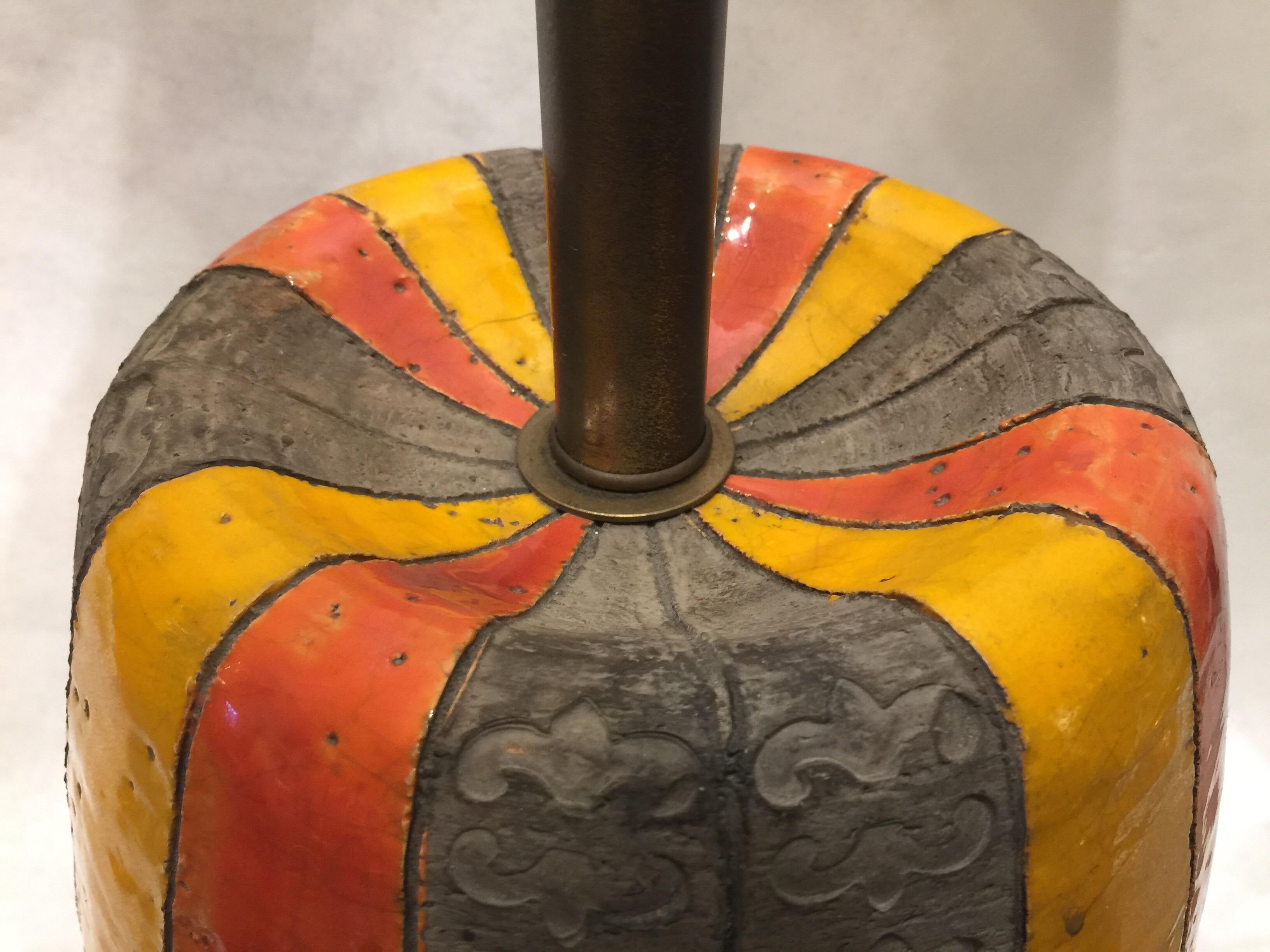 This very large Bitossi lamp designed by Aldo Londi features rich vibrant colors and a rough volcanic style textured print to the base. Labelled and in good original wiring working condition. No shade shown or included.

Note: Base or ceramic