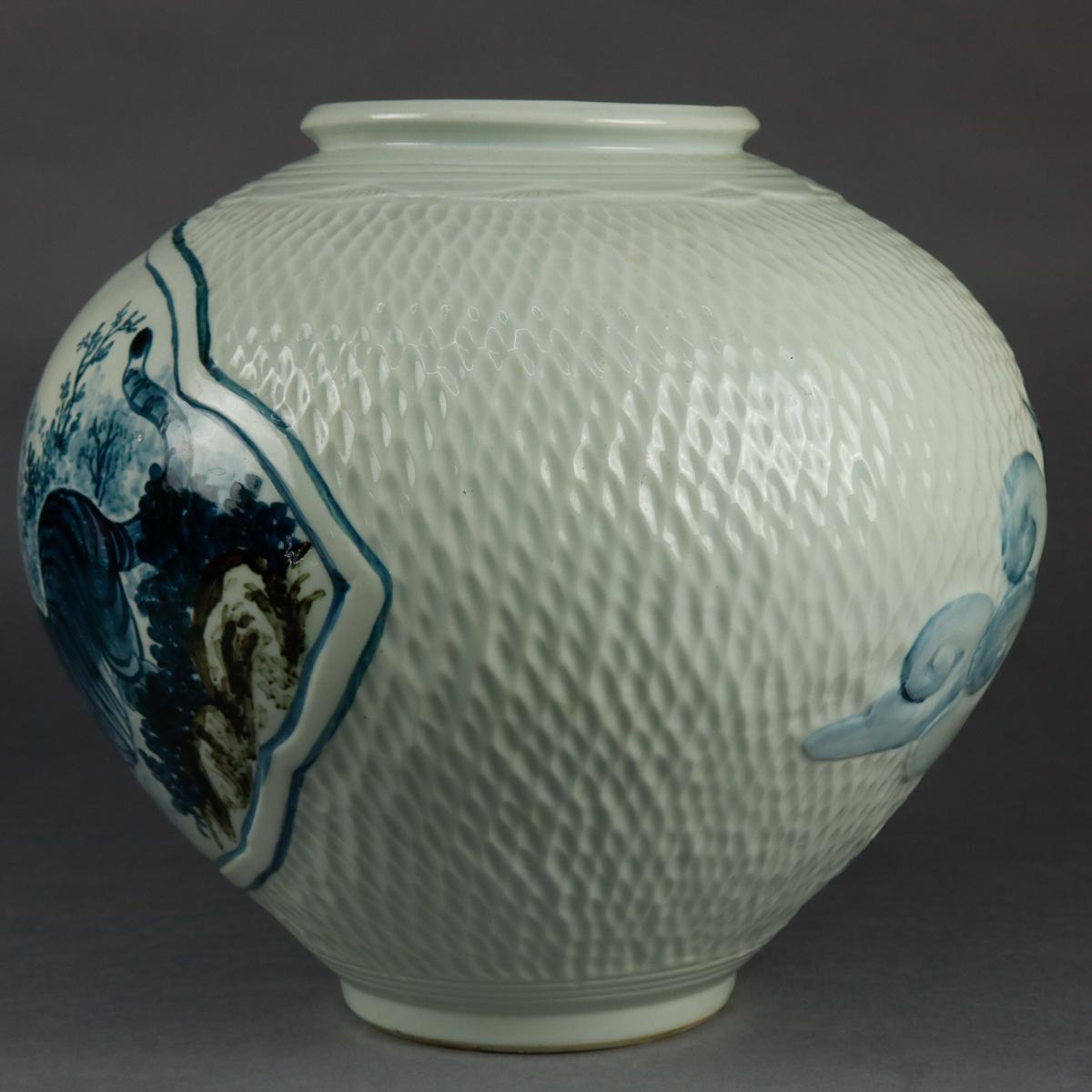 An oversized Chinese pottery vase offers bulbous form with all-over dimple texturing, reserve with hand painted tiger scene, high relief stylized clouds and in-flight heron, chop mark verbiage and signature as photographed, 20th century

Measures: