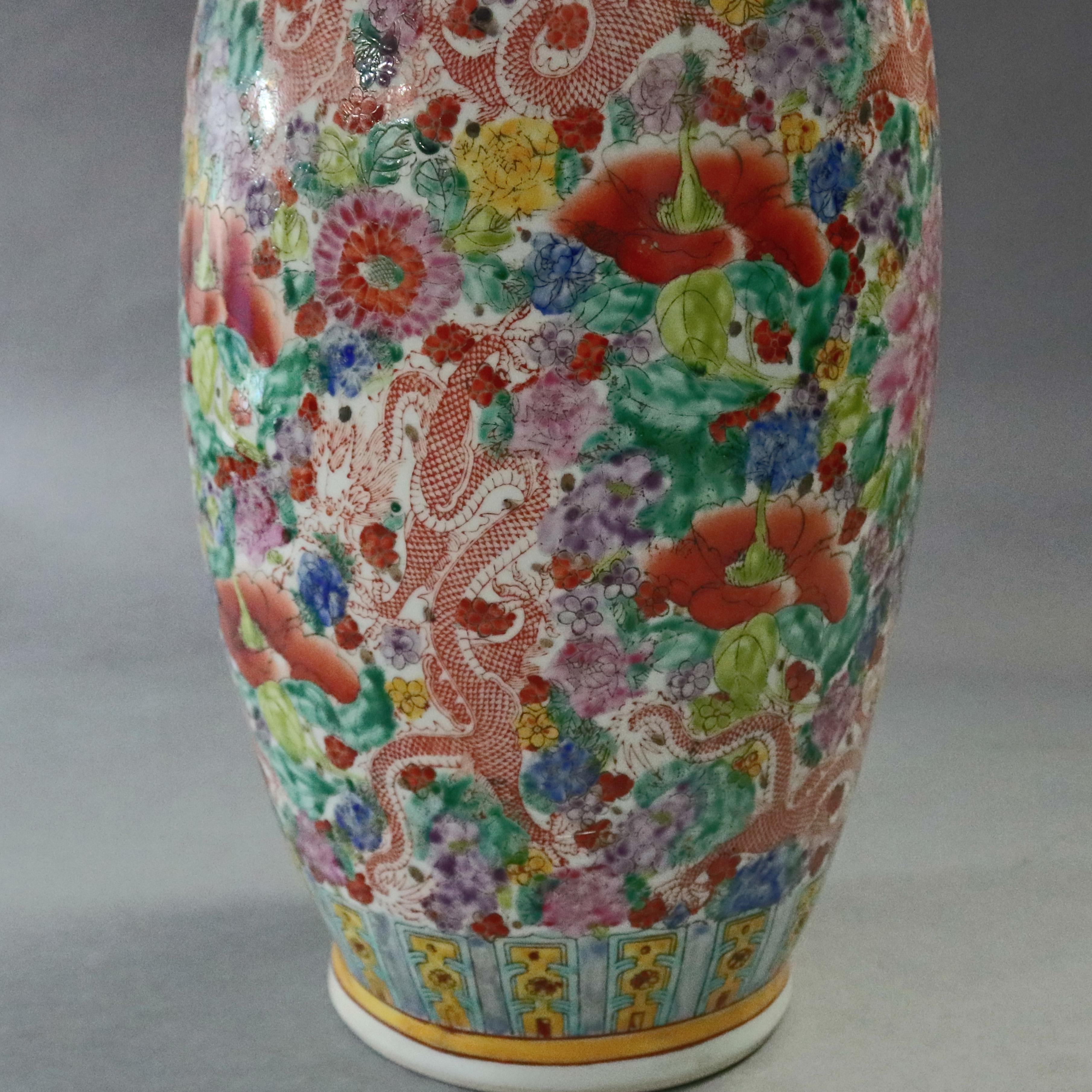 An oversized Chinese porcelain vase offers all-over hand painted floral and dragon decoration with repeating patterns in base, shoulder and lip collars, signed on base as photographed, 20th century

***DELIVERY NOTICE – Due to COVID-19 we are