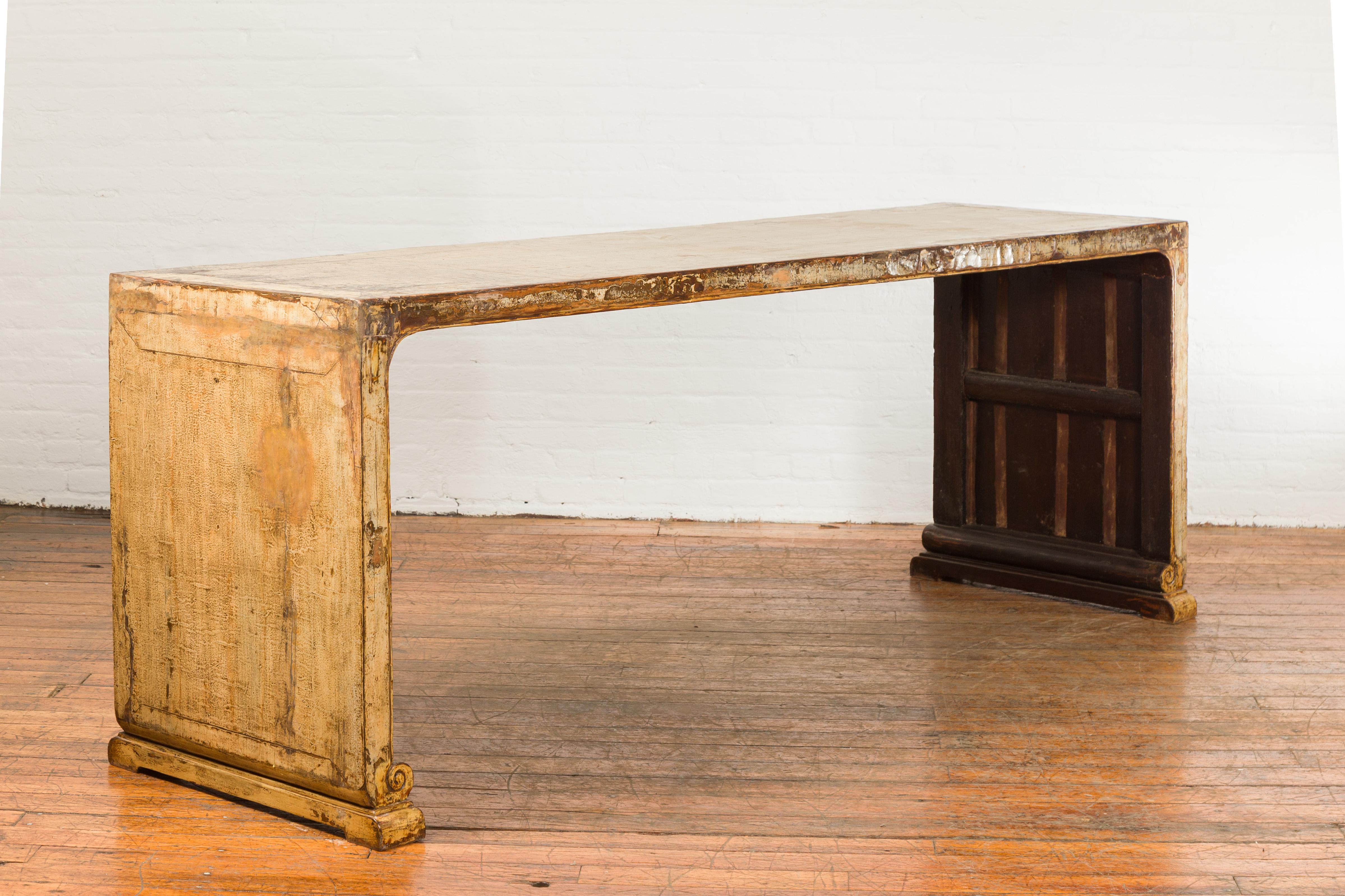 An oversized Chinese vintage altar console table from the mid 20th century, with distressed rubbed patina and scrolling extremities. Created in China during the midcentury period, this altar table draws our attention with its great proportions and